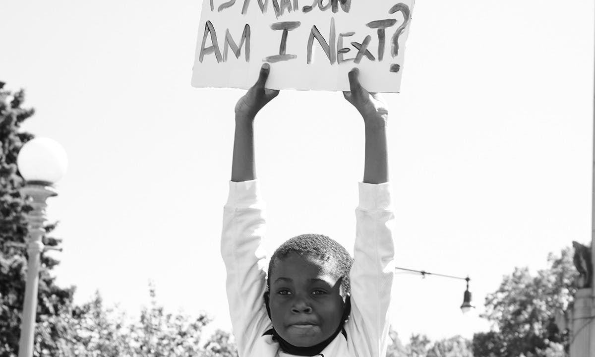 Child raising "AM I NEXT?" Poster