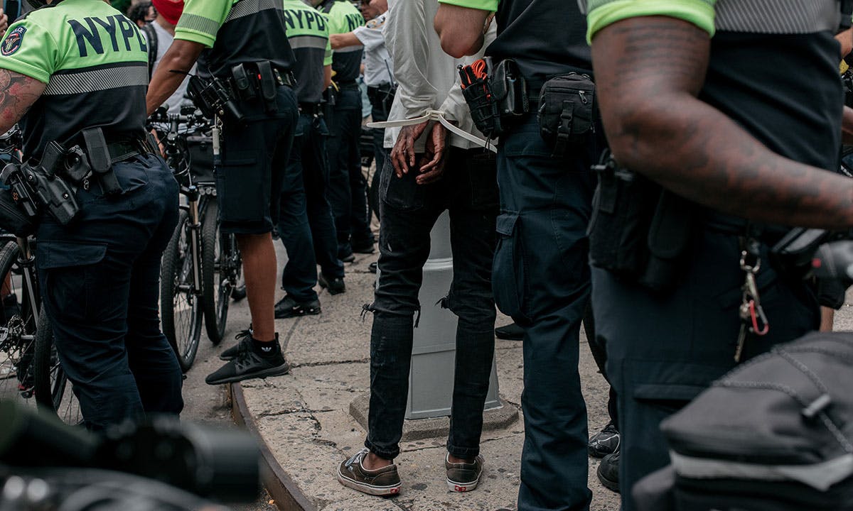 A protester is arrested by NYPD officers during a march against police brutality