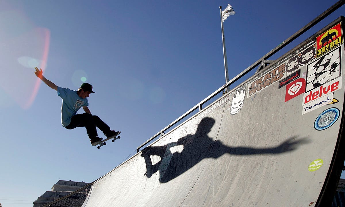 A skateboarder rides a ramp outside the World Cyber Games