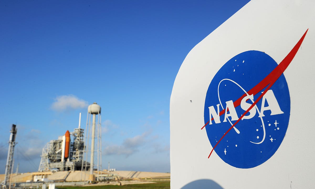 The NASA logo on a protective box for a camera near the space shuttle Endeavour