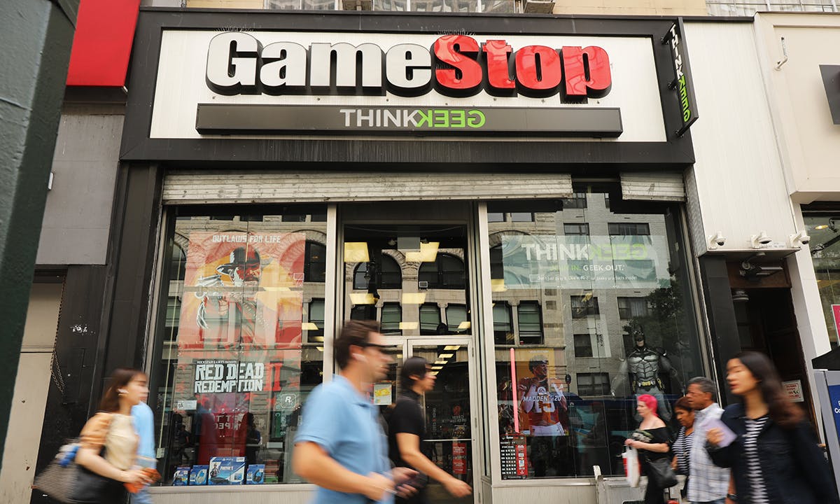 People pass a GameStop store in lower Manhattan