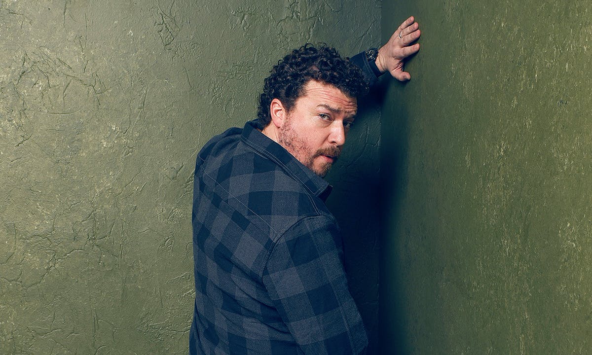 Danny McBride urinating on a green wall