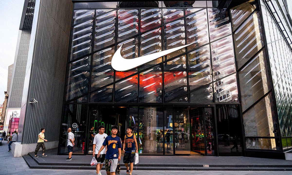 buyers leaving nike store with swoosh logo