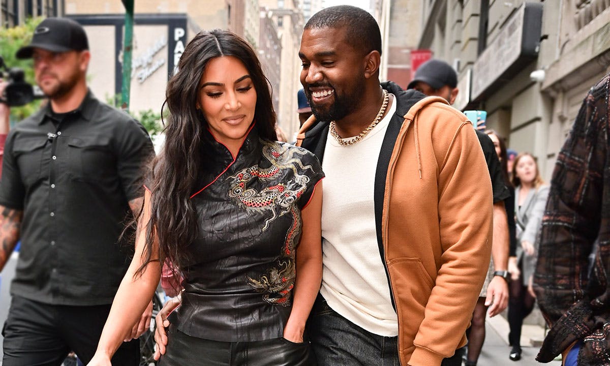 Kim Kardashian and Kanye West smiling walking together