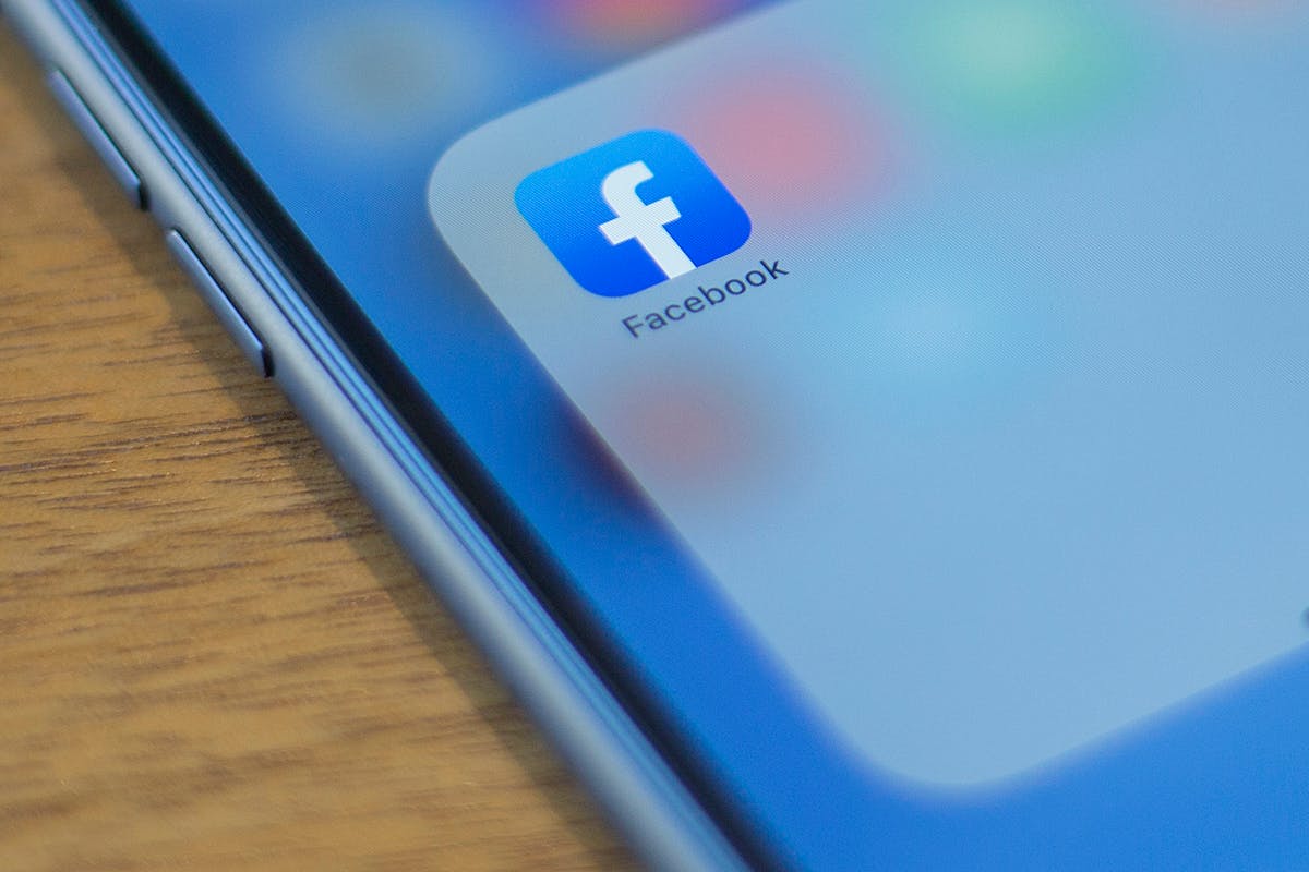 The Facebook logo is seen on a phone