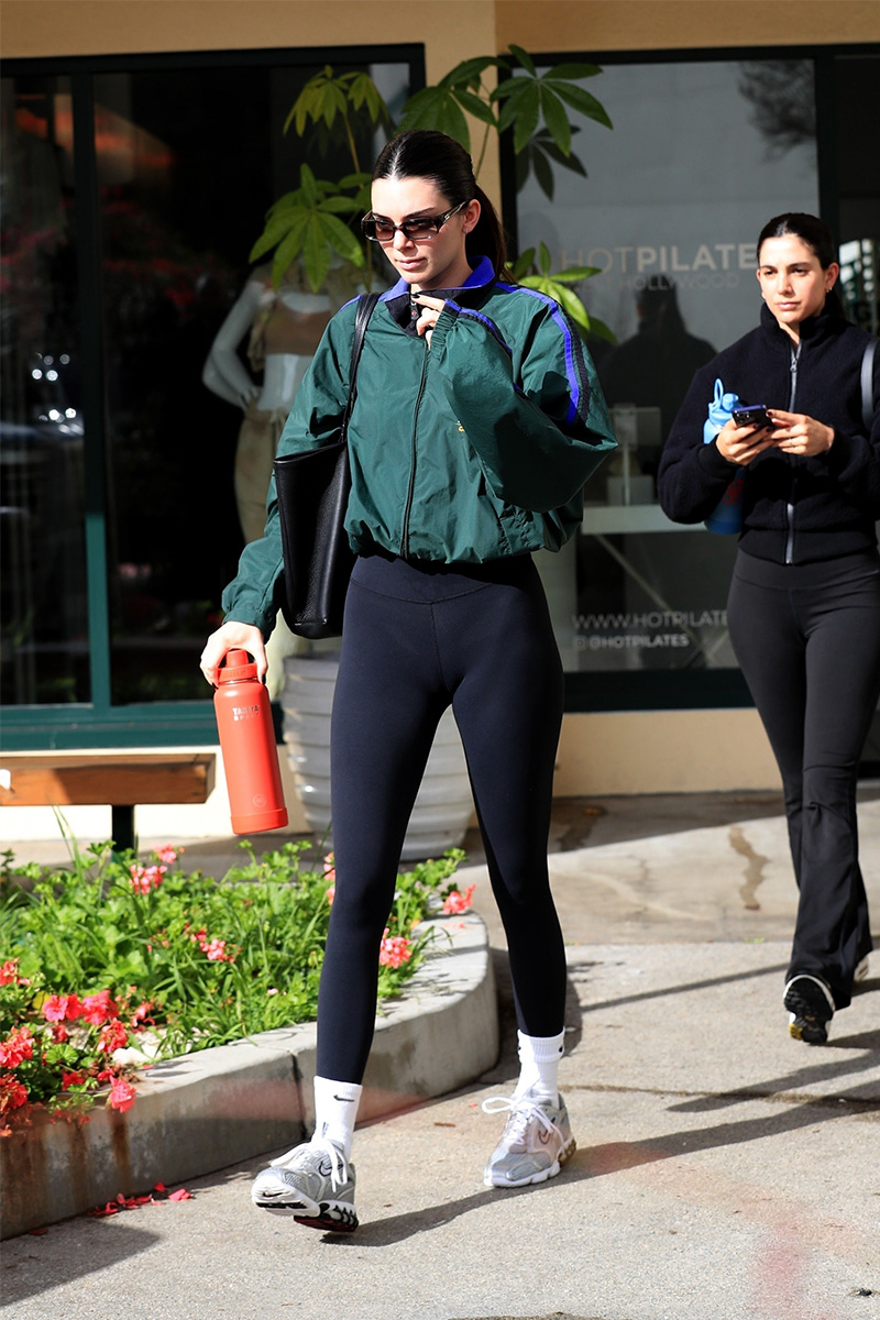 Kendall Jenner in black leggings, black tote, white socks and