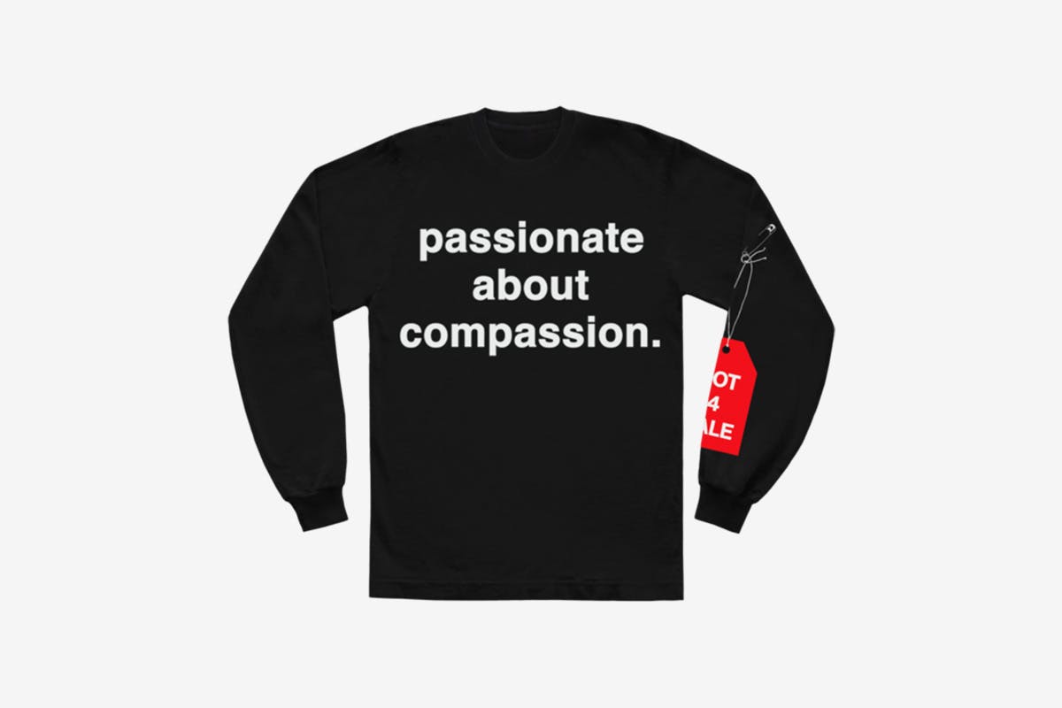 image of Andre' 3000's new sweater with slogan from tour jumpsuits