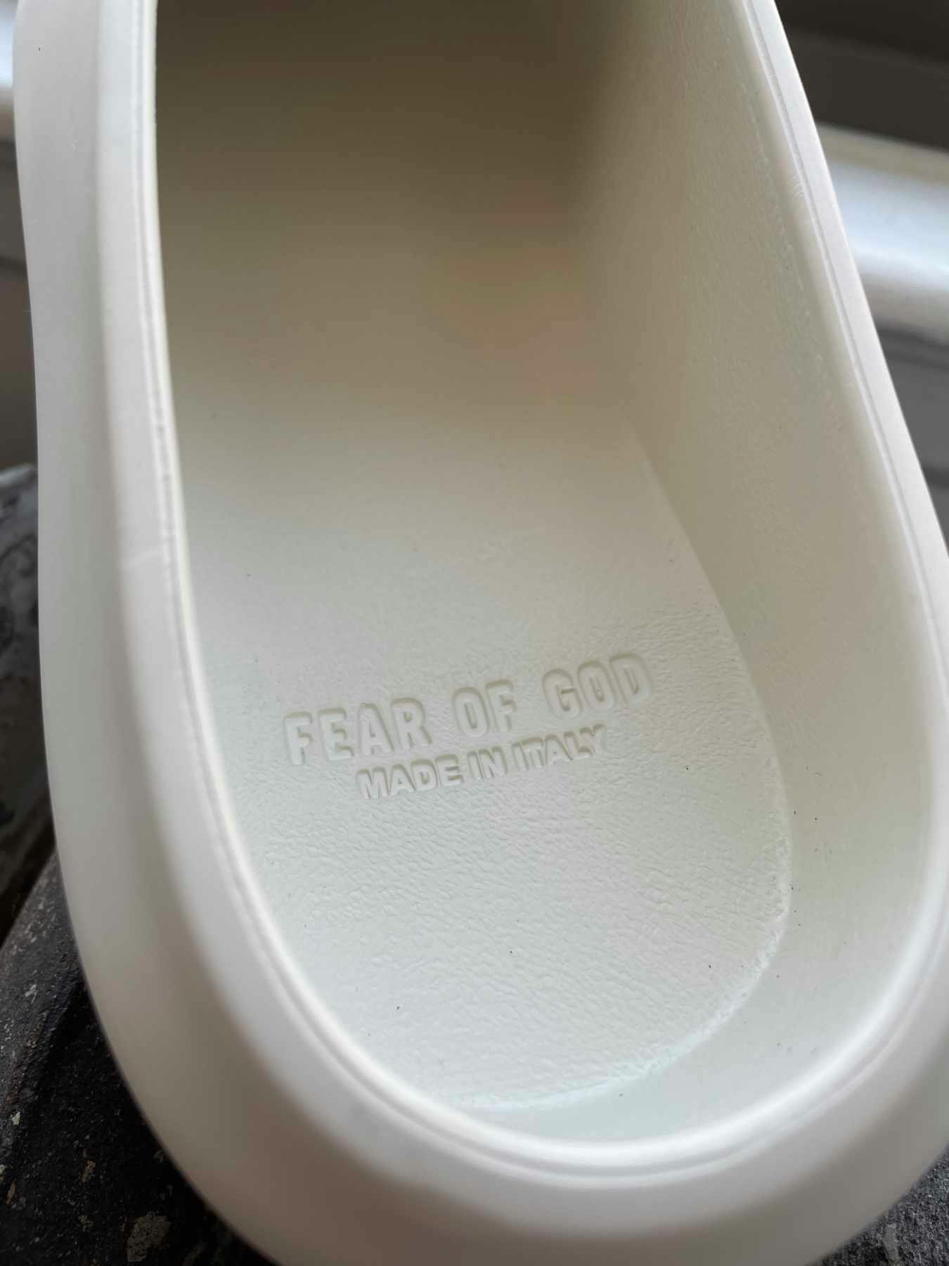 A detailed photograph showing the insole of Fear of God's California 2.0 slip-on shoe in Cream