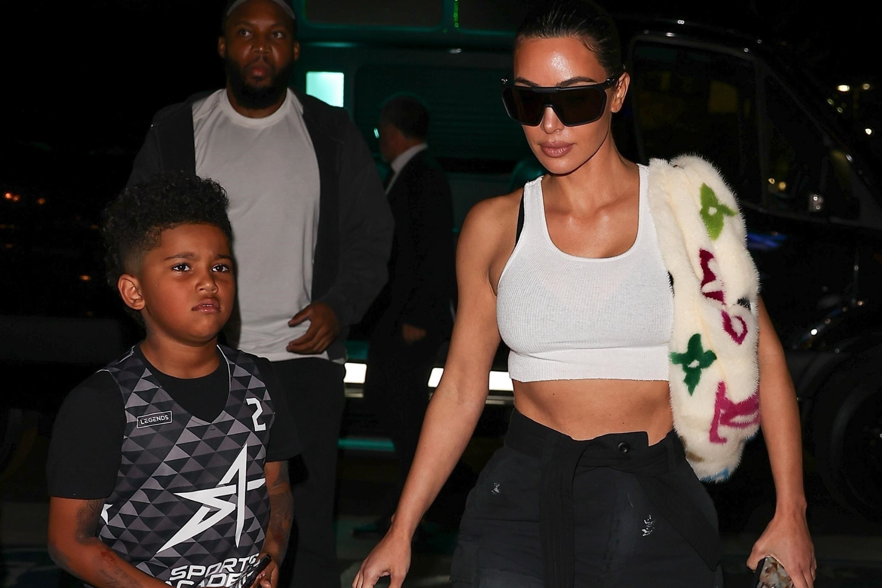 Kim Kardashian wears a rare 33K Louis Vuitton bum bag rendered in Takashi Murakami's limited edition 'Monogram Multicolore' mink fur to her son Saint's basketball game and dinner at Islands Restaurant in Thousand Oaks.