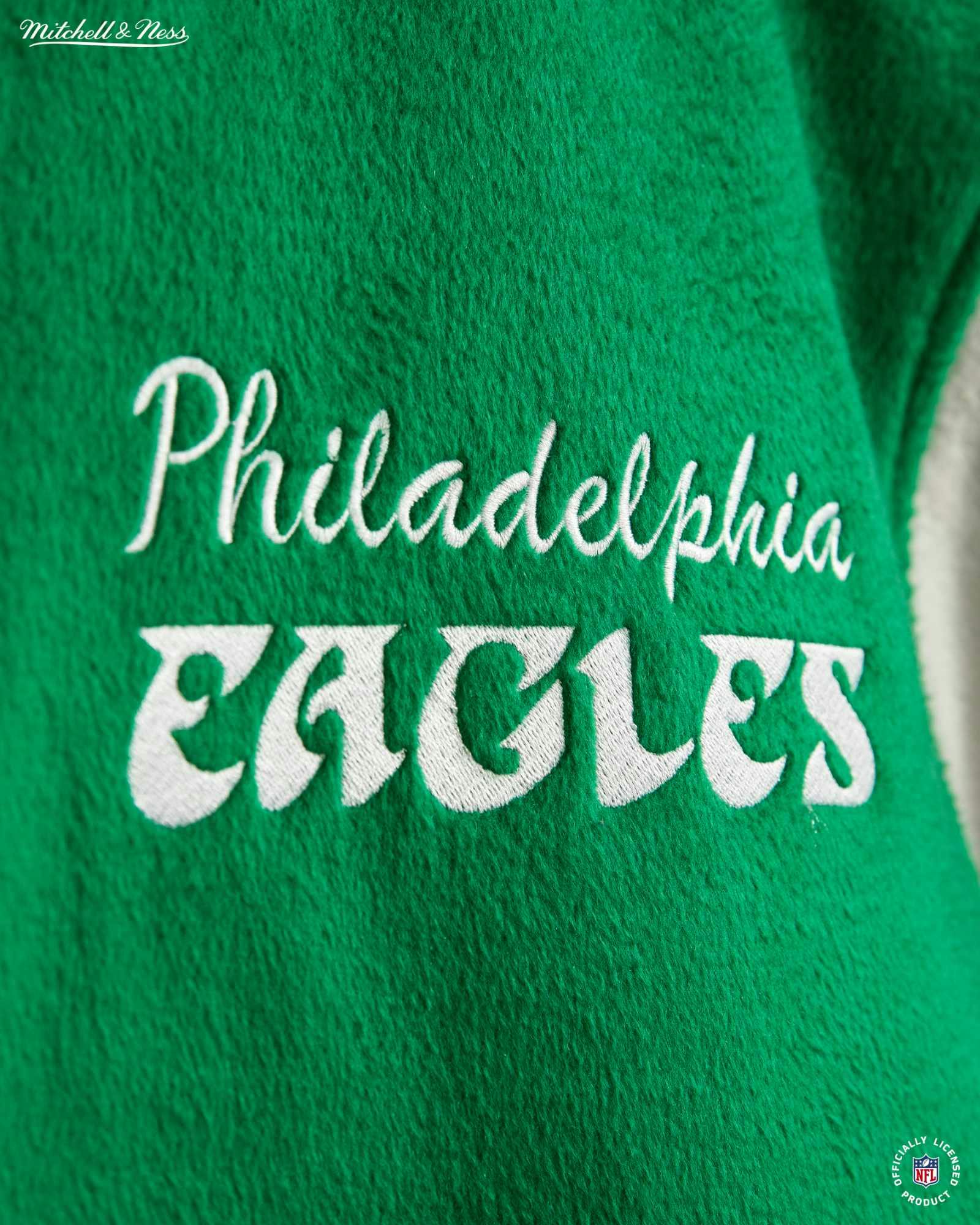 Product photos of Mitchel & Ness' Princess Diana Eagles jacket recreation in green wool and silver leather releasing in November 2023