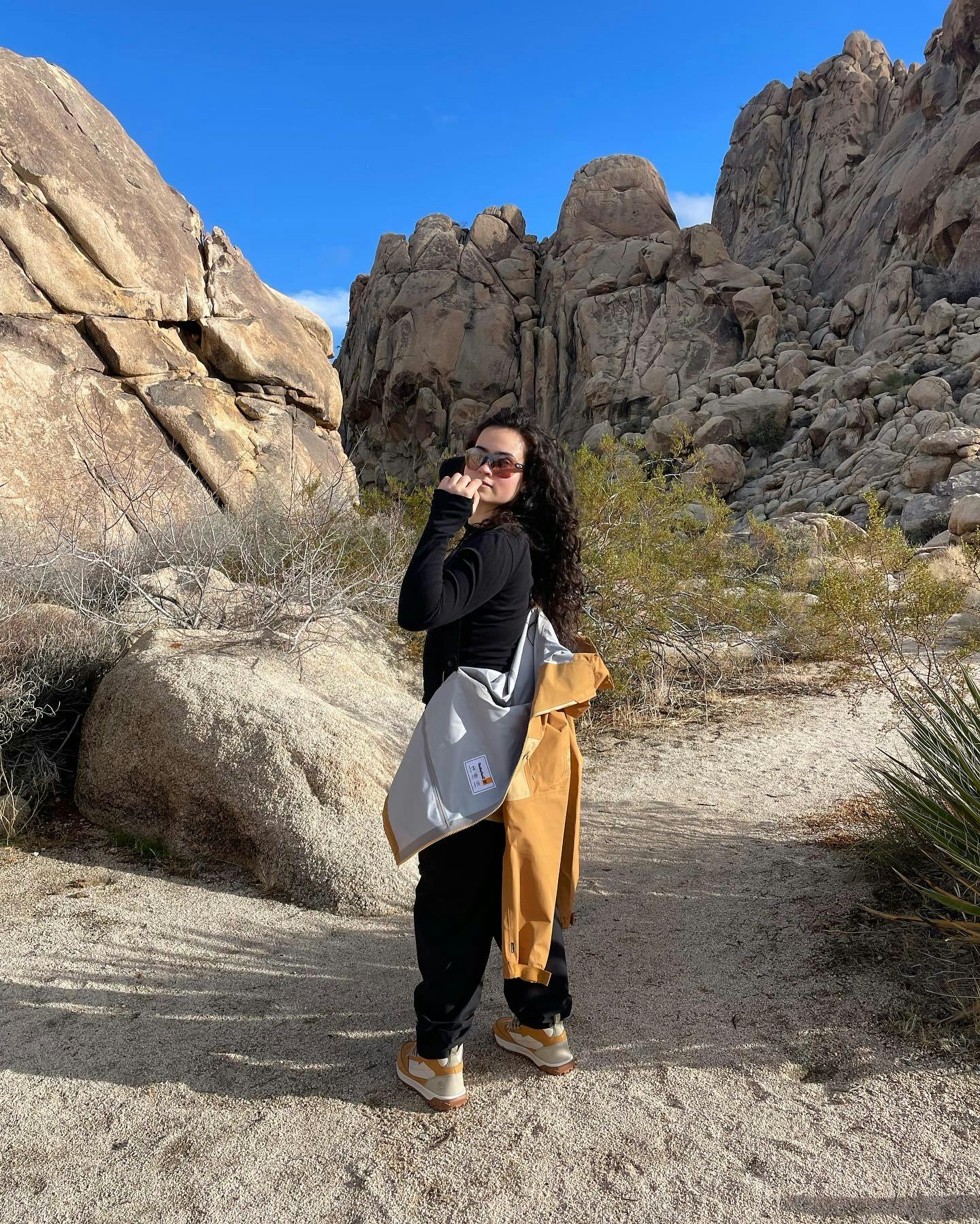 Talia Restrepo hiking in Joshua Tree wearing Timberlands