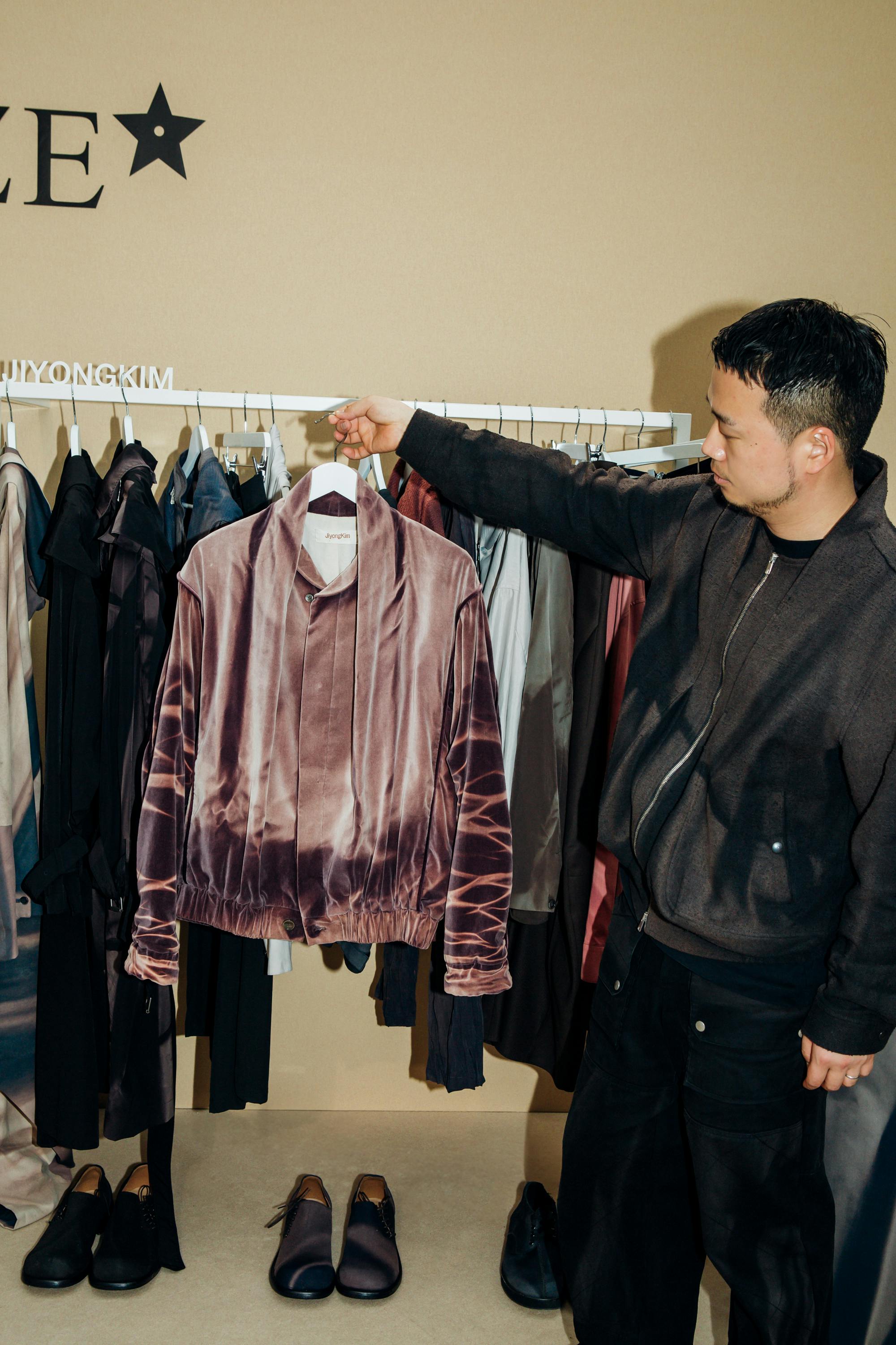 Designer JiyongKim seen holding his clothes at the 2024 LVMH Prize