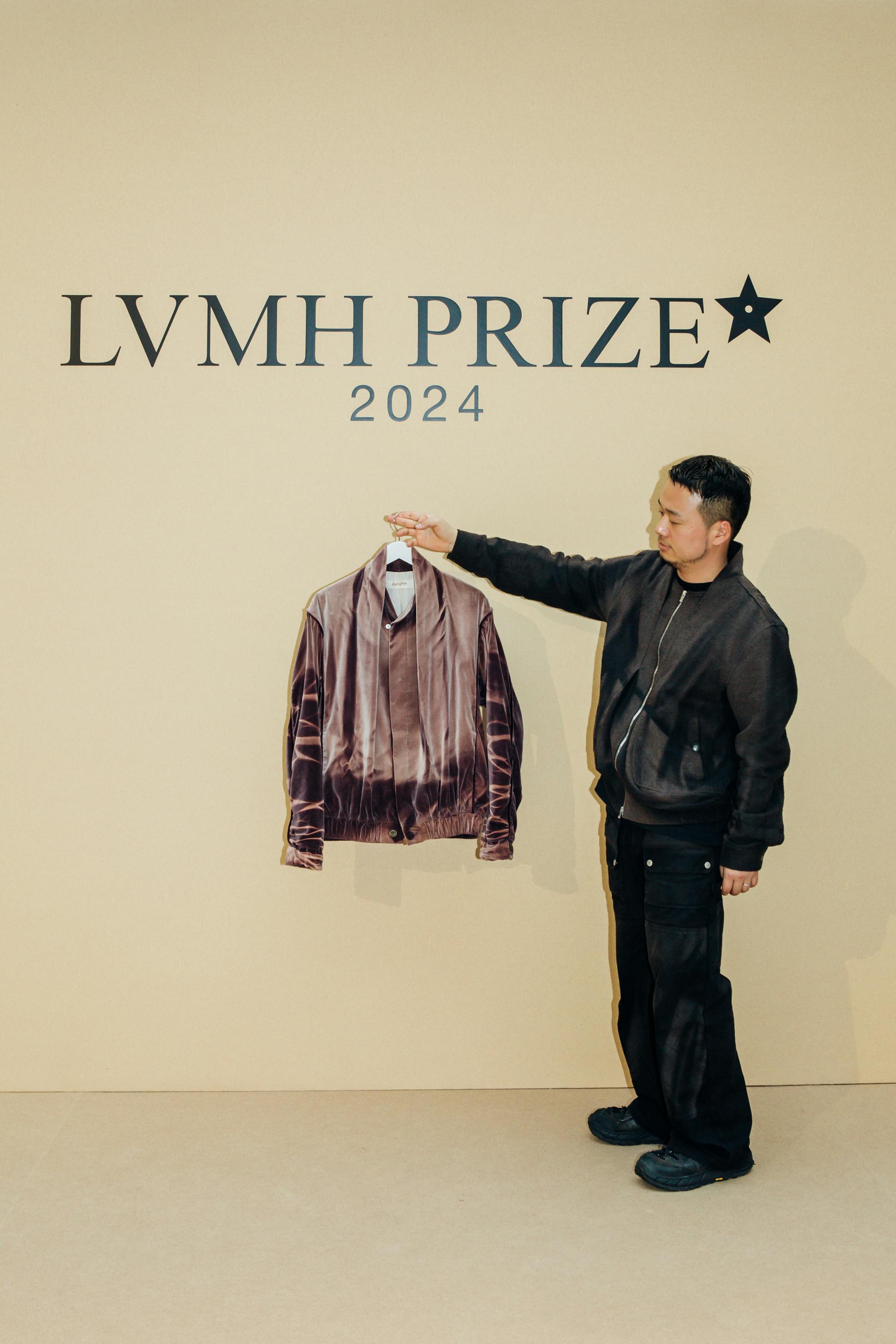 Designer JiyongKim seen holding his clothes at the 2024 LVMH Prize