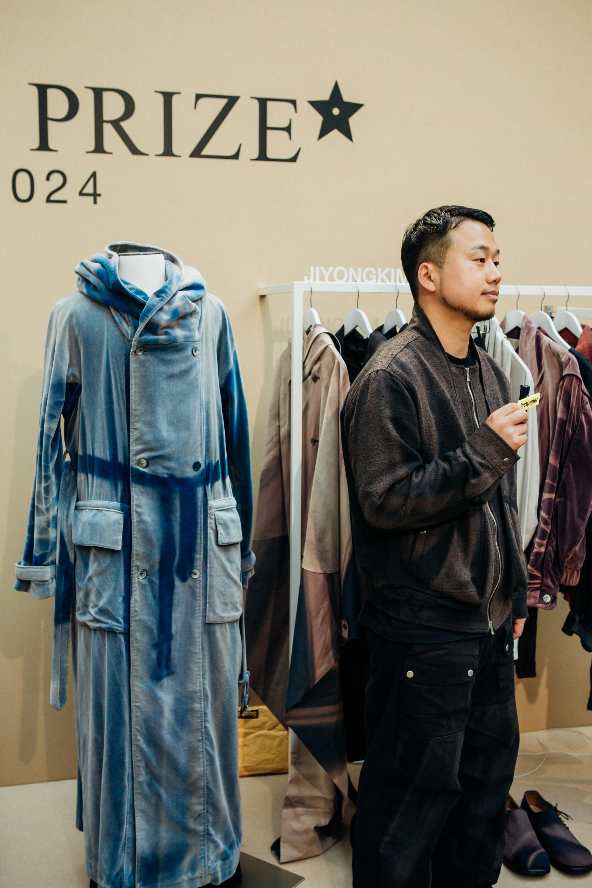 Designer JiyongKim seen holding his clothes at the 2024 LVMH Prize