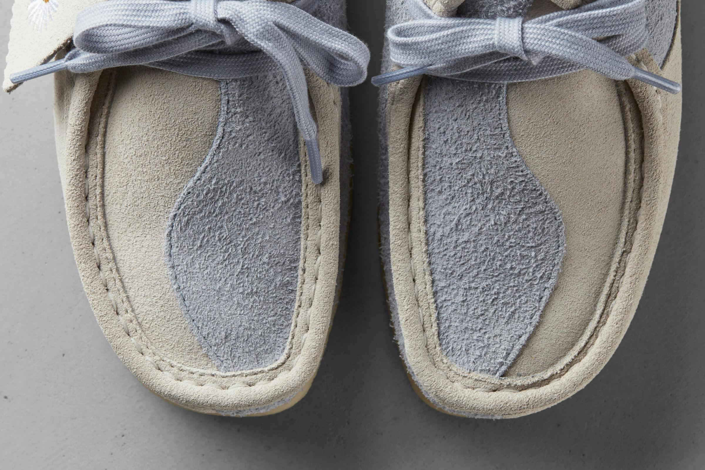 Close-up of the front of two moccasin-style shoes with a yin-yang pattern on the upper