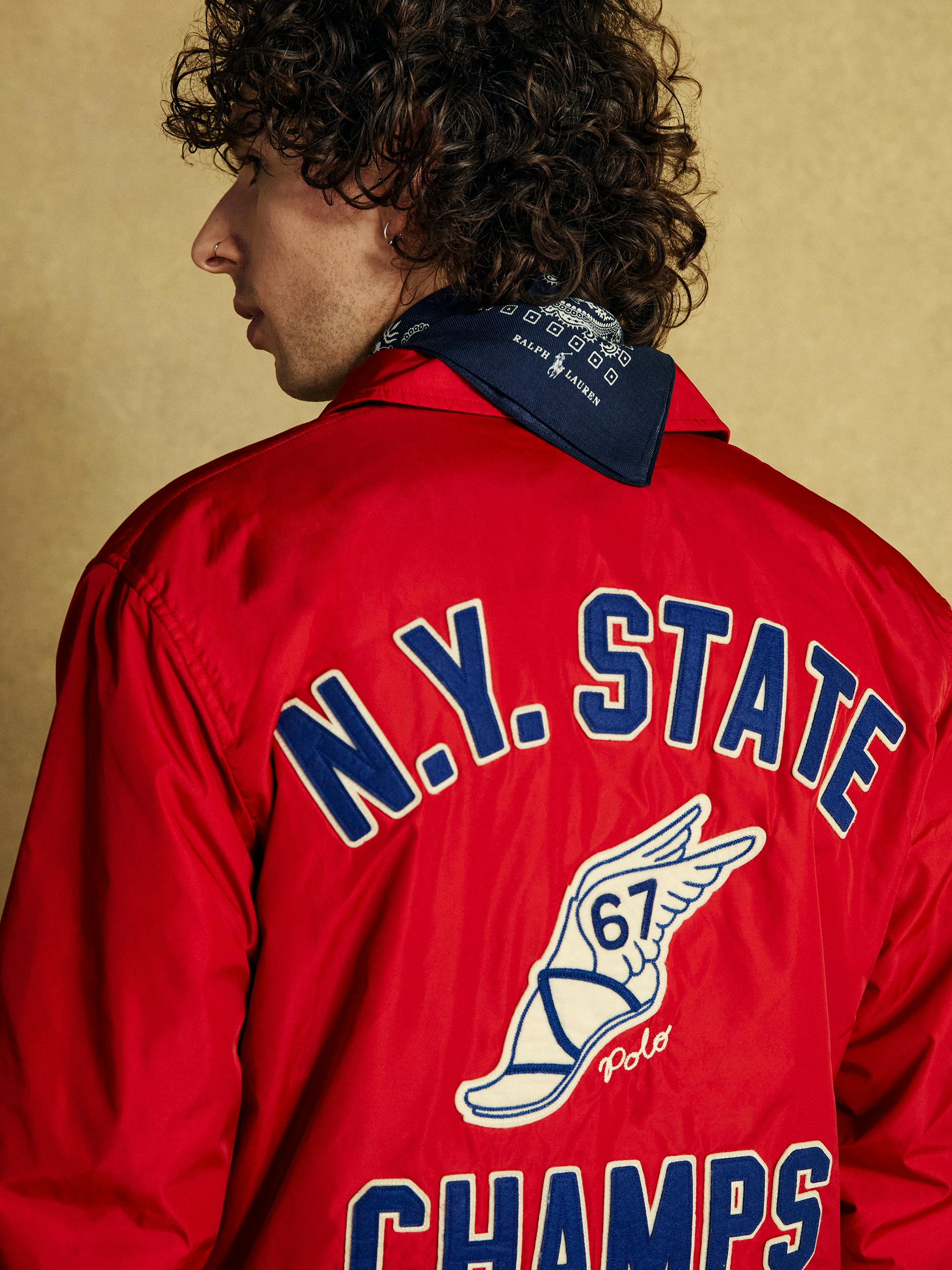 Shot from behind of a male model's vintage red varsity jacket