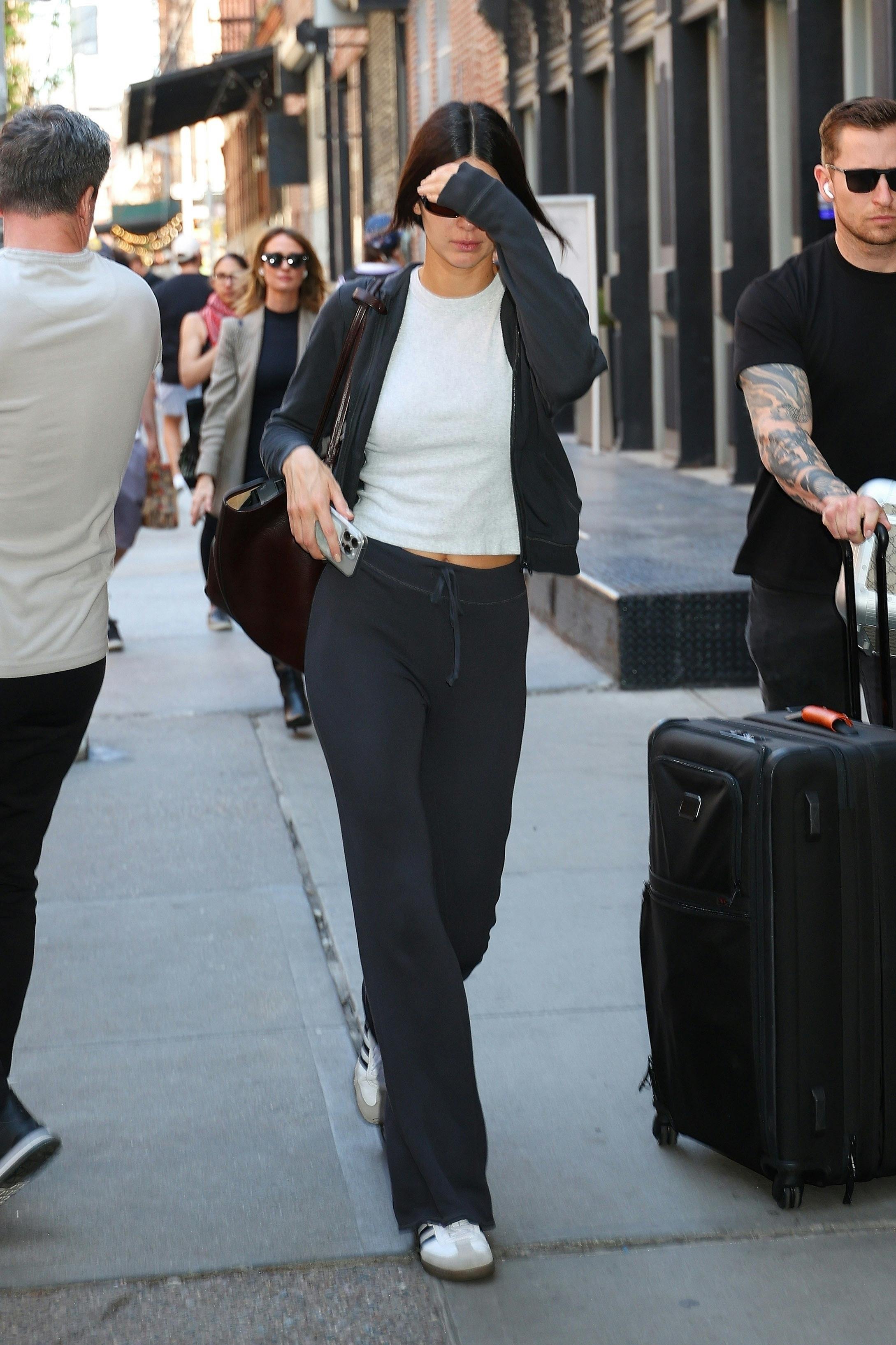 Bad Bunny & Kendall Jenner leave the Greenwich Hotel in New York after the 2024 Met Gala wearing Bottega Veneta & adidas sneakers