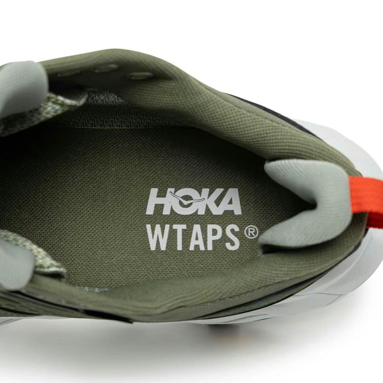 HOKA & WTAPS' green Anacapa 2 Low GTX sneaker collaboration seen from the logos on the insole