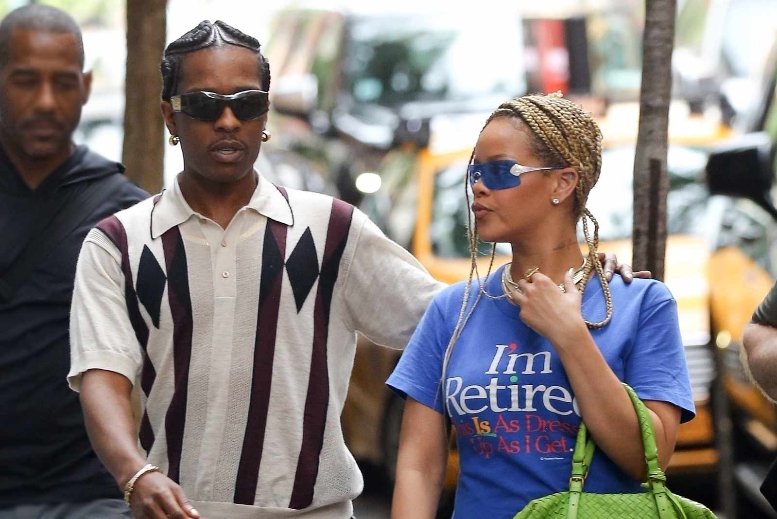 A$AP Rocky & Rihanna seen in New York with a striped shirt, leather Bottega Veneta jeans, a yellow Bottega Veneta handbag, blue I'm Retired T-shirt, red PUMA sneakers
