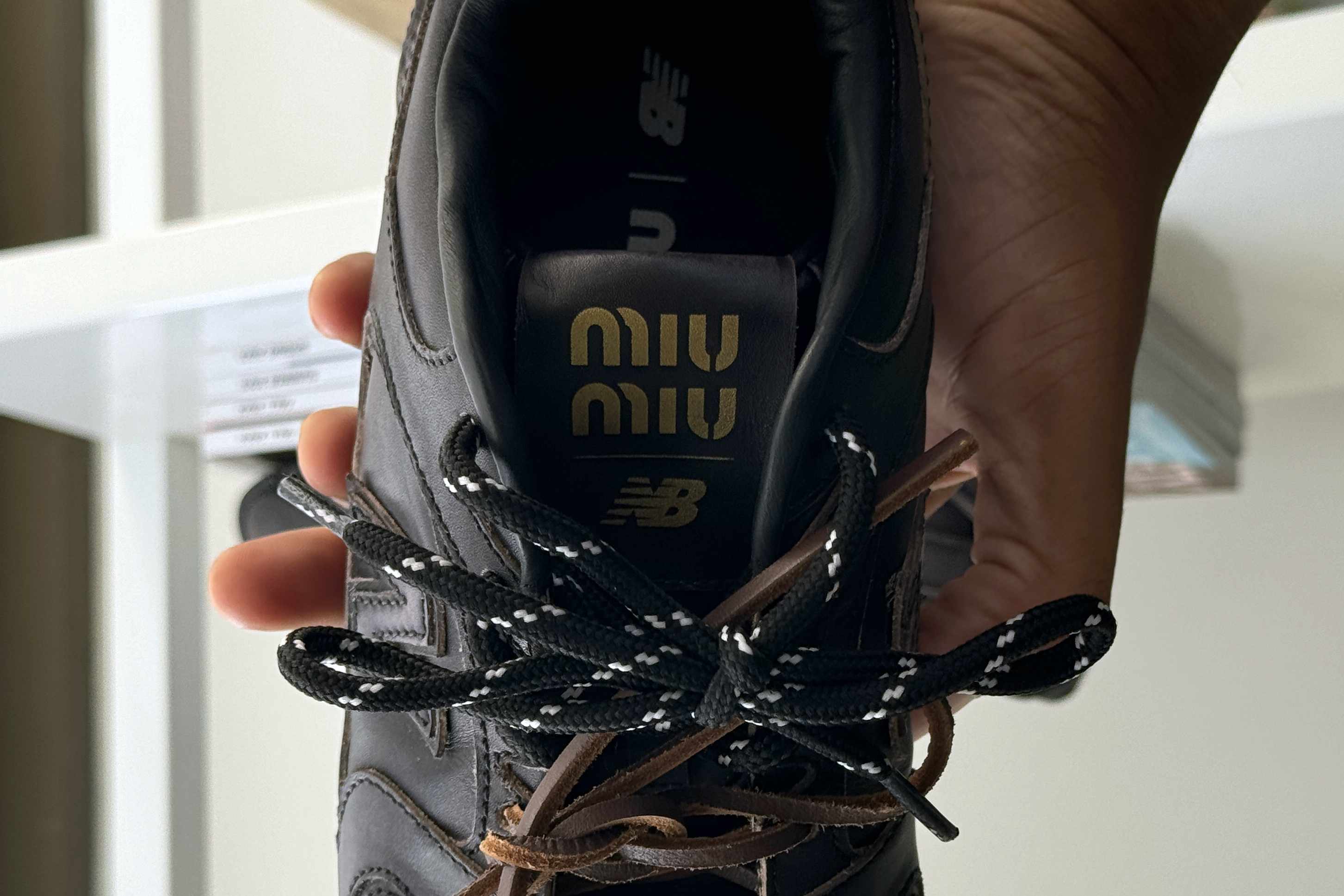 Miu Miu's New Balance 530 sneaker collab in black leather with two laces