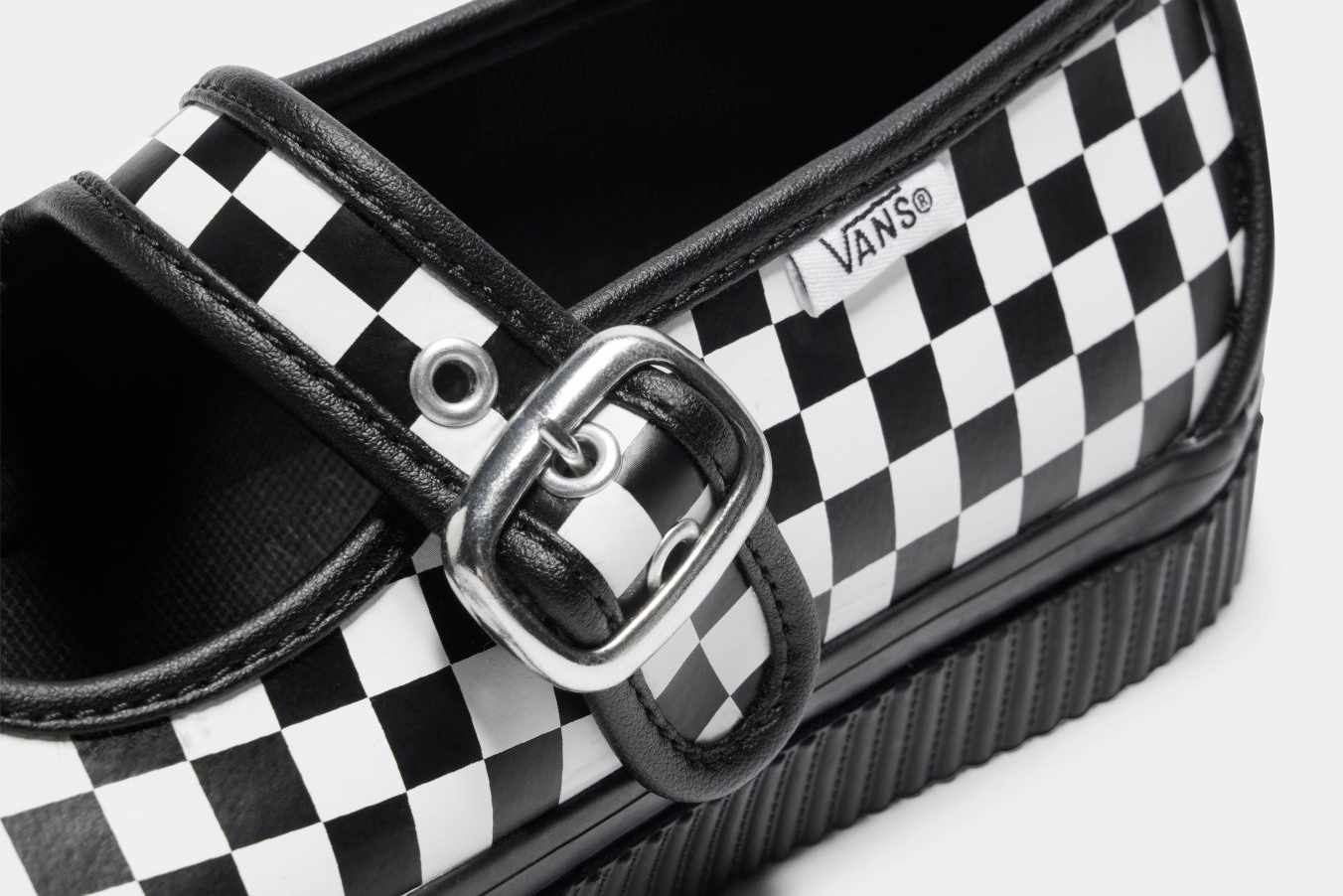 Vans' checkerboard mary jane style 93 skate sneaker with a black leather lining and silver buckle