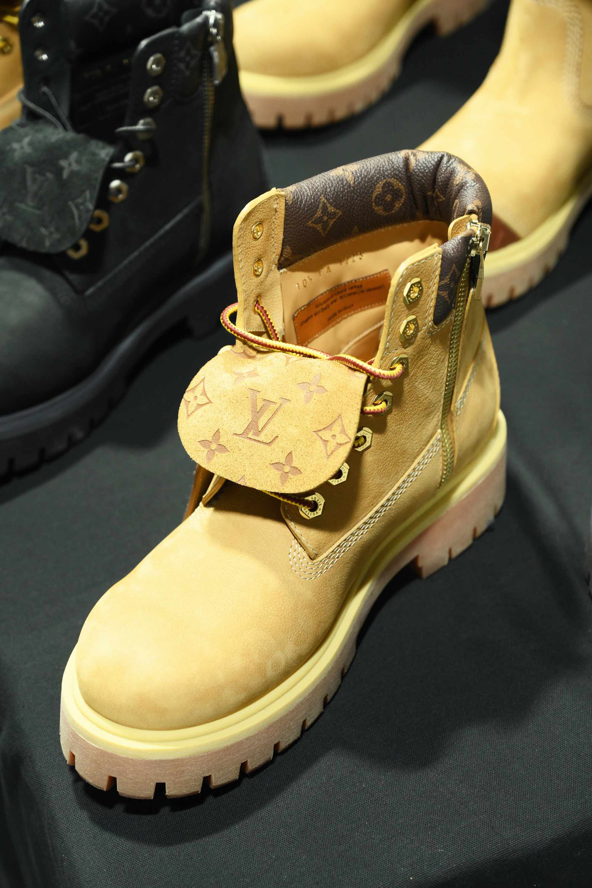 Louis Vuitton's Timberland boot collab revealed by Pharrell Williams, including beige and black 6" leather boots and ranger-style pull ons in Louis Vuitton-monogrammed boxes