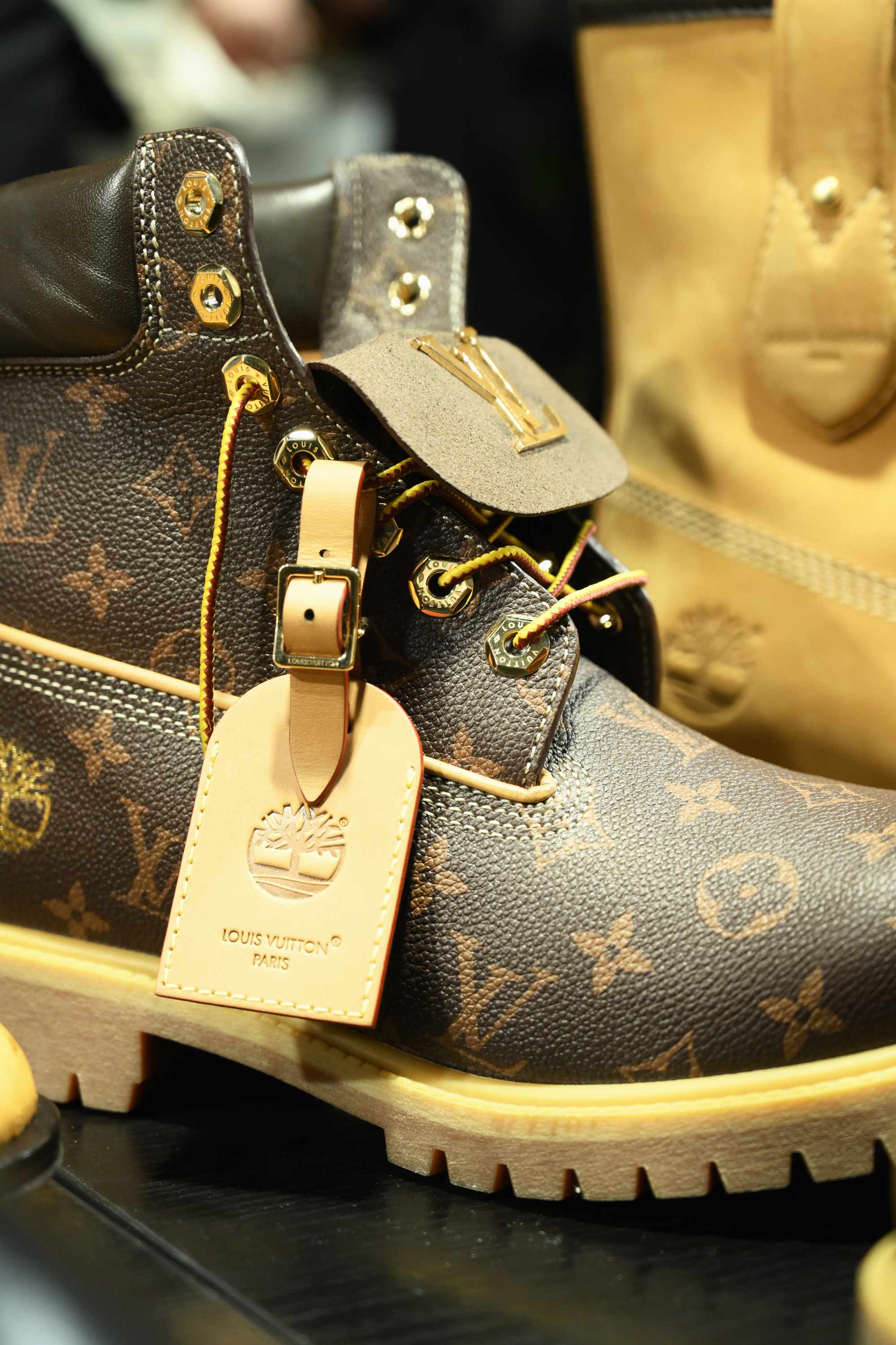 Louis Vuitton's Timberland boot collab revealed by Pharrell Williams, including beige and black 6" leather boots and ranger-style pull ons in Louis Vuitton-monogrammed boxes