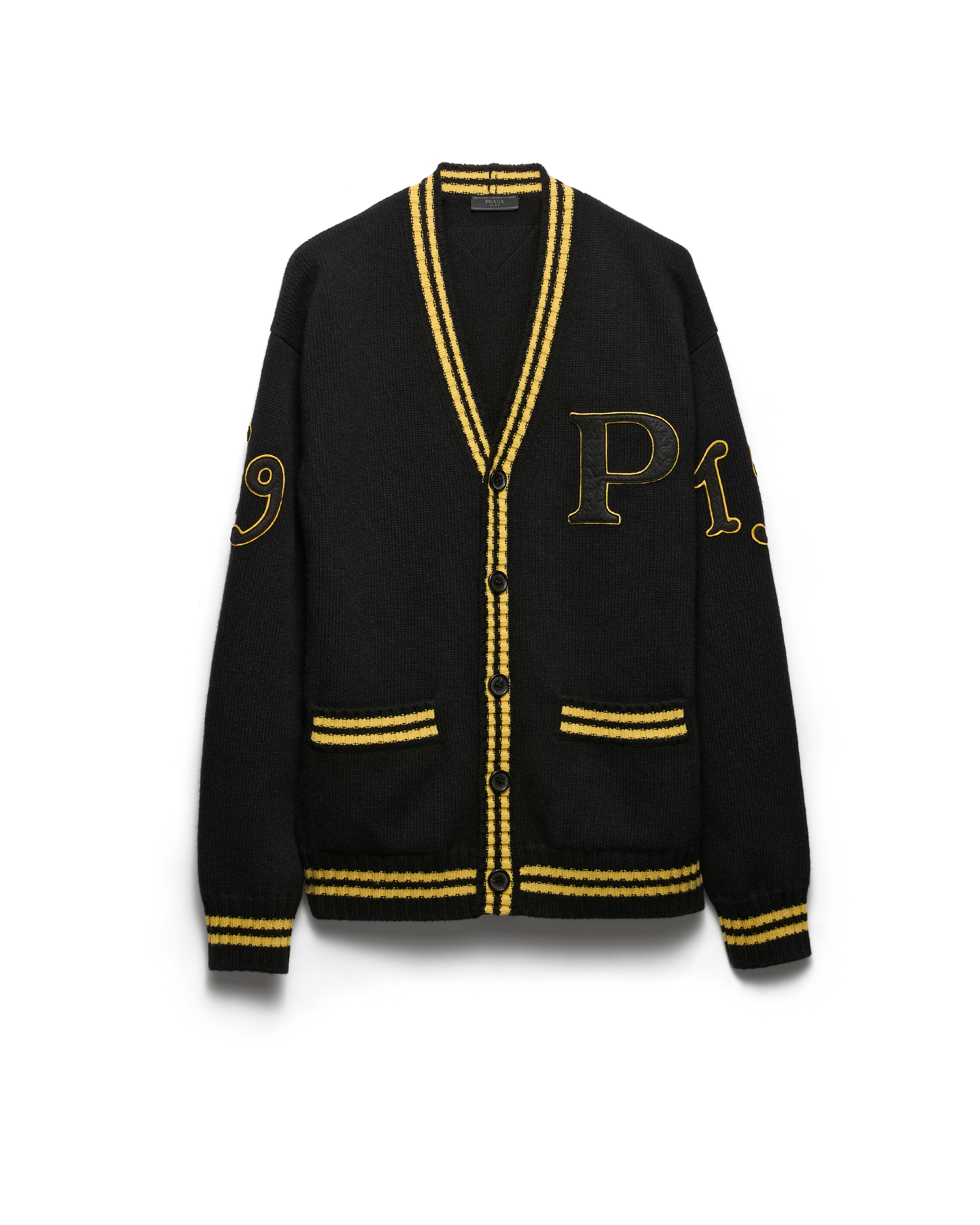 Prada's 1913 menswear capsule, including white varsity jacket, black bomber and knit cardigan
