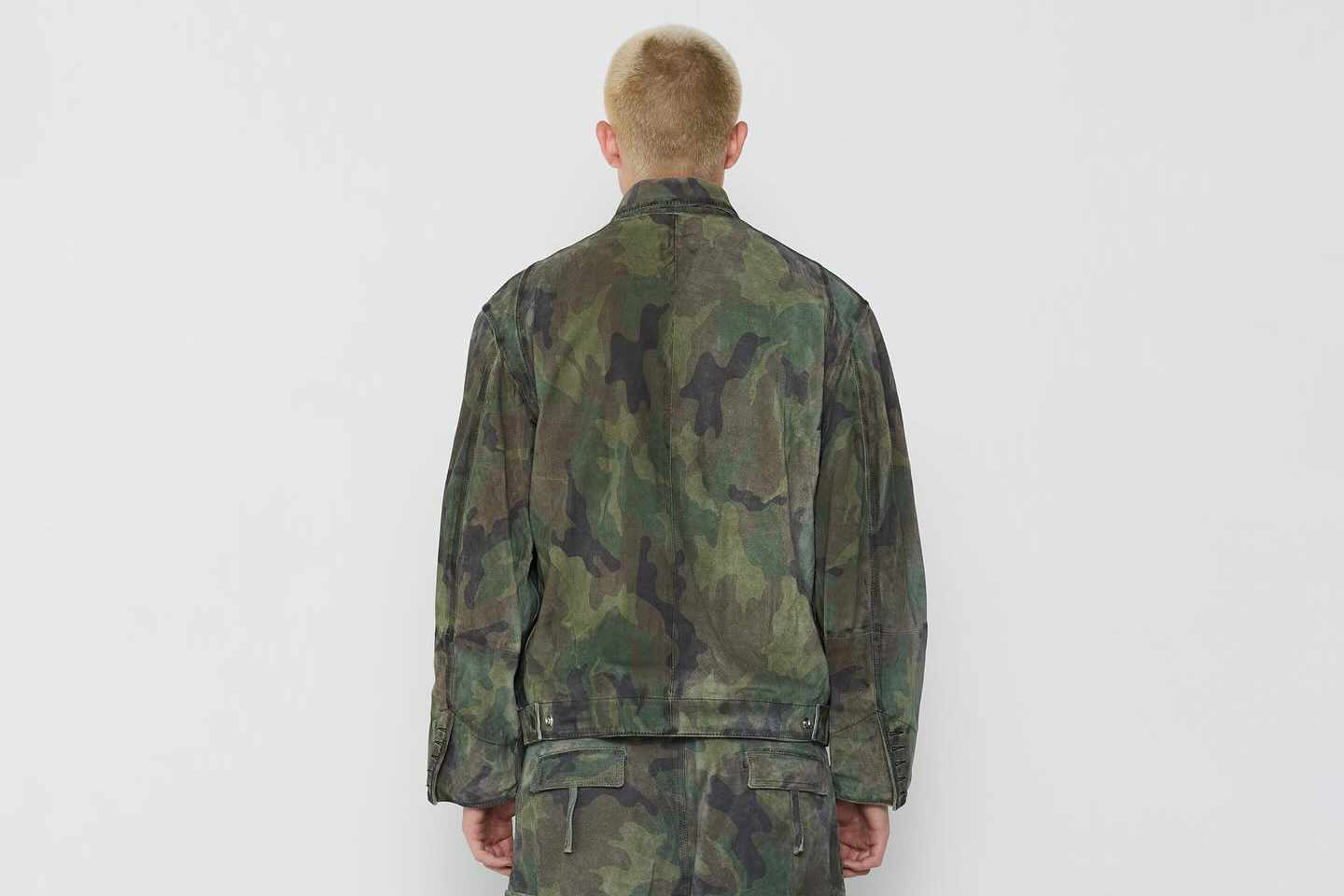 A model wears a camouflage 424 outfit, including camo shorts and camo pants