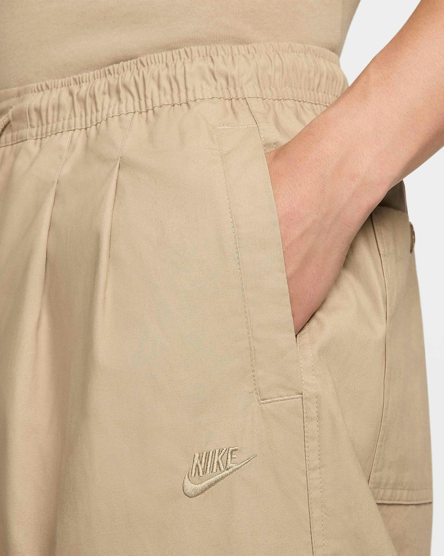 Nike Balloon Pant in beige and black colorways, with an elastic waist, pleats and loose leg