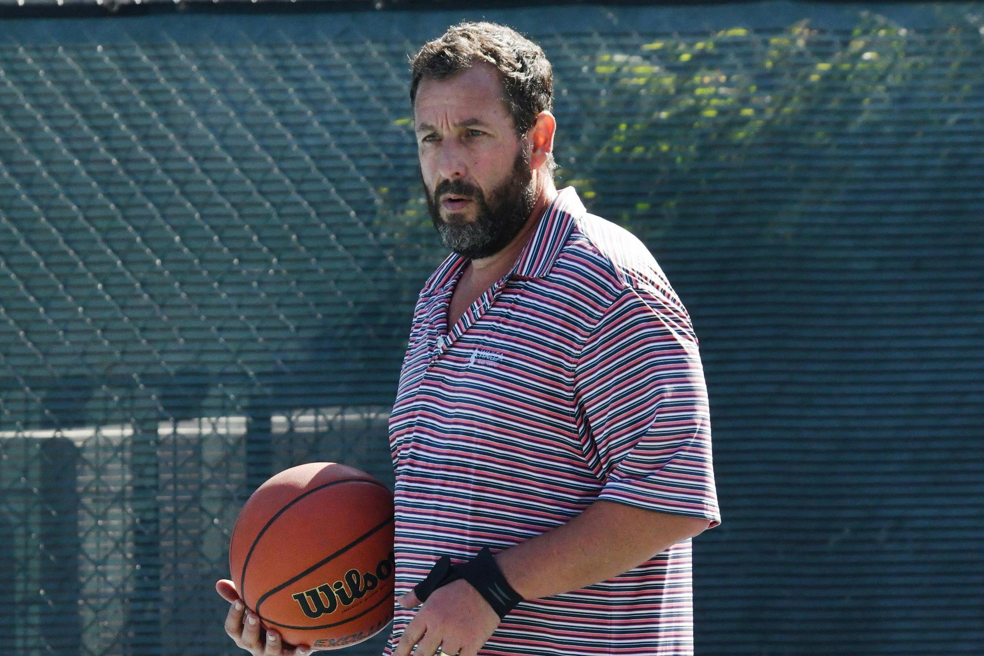 Adam Sandler wearing shorts while playing basketball on August 5, 2024