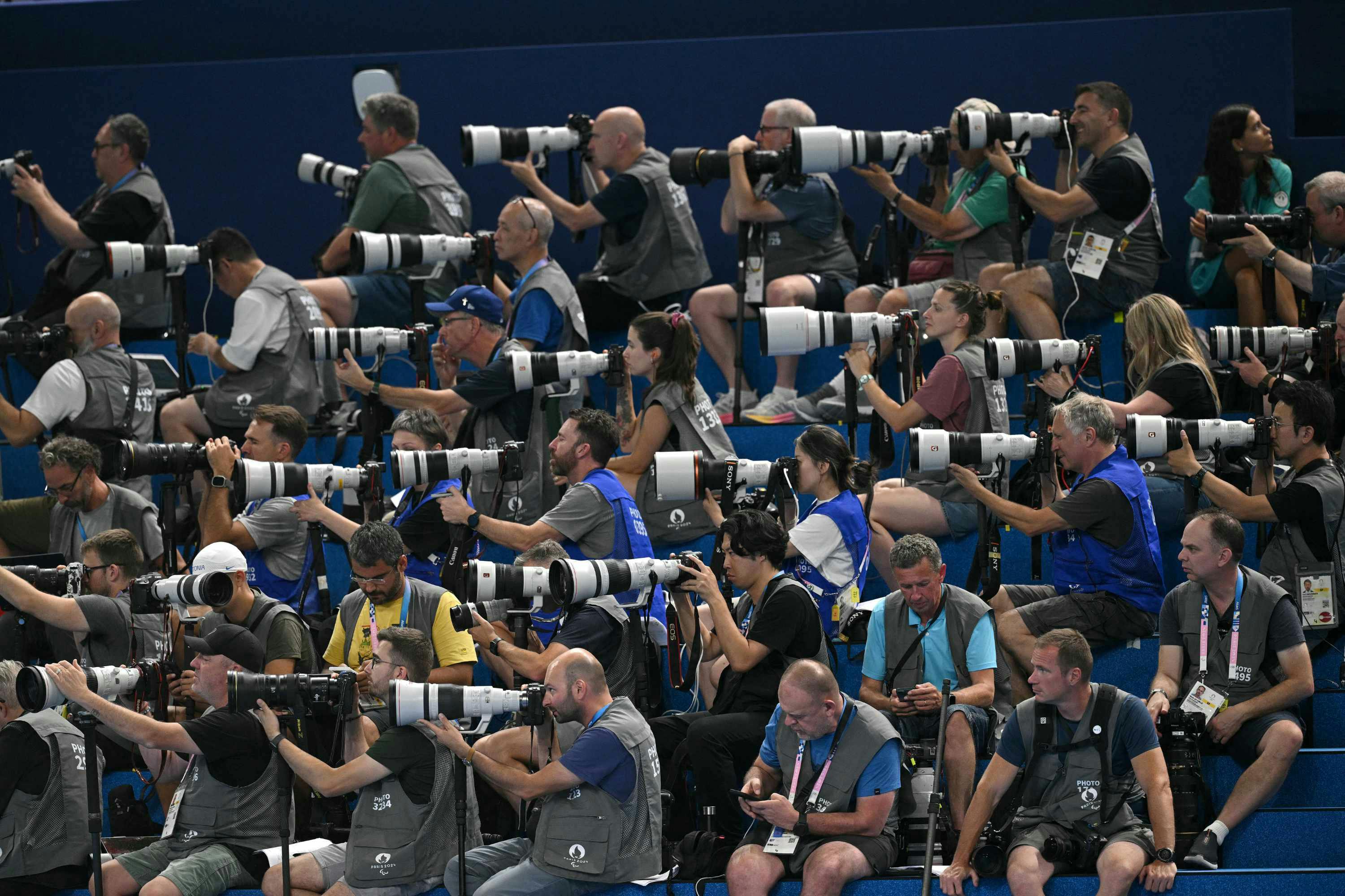 Olympics 2024 photographers wear brown vests