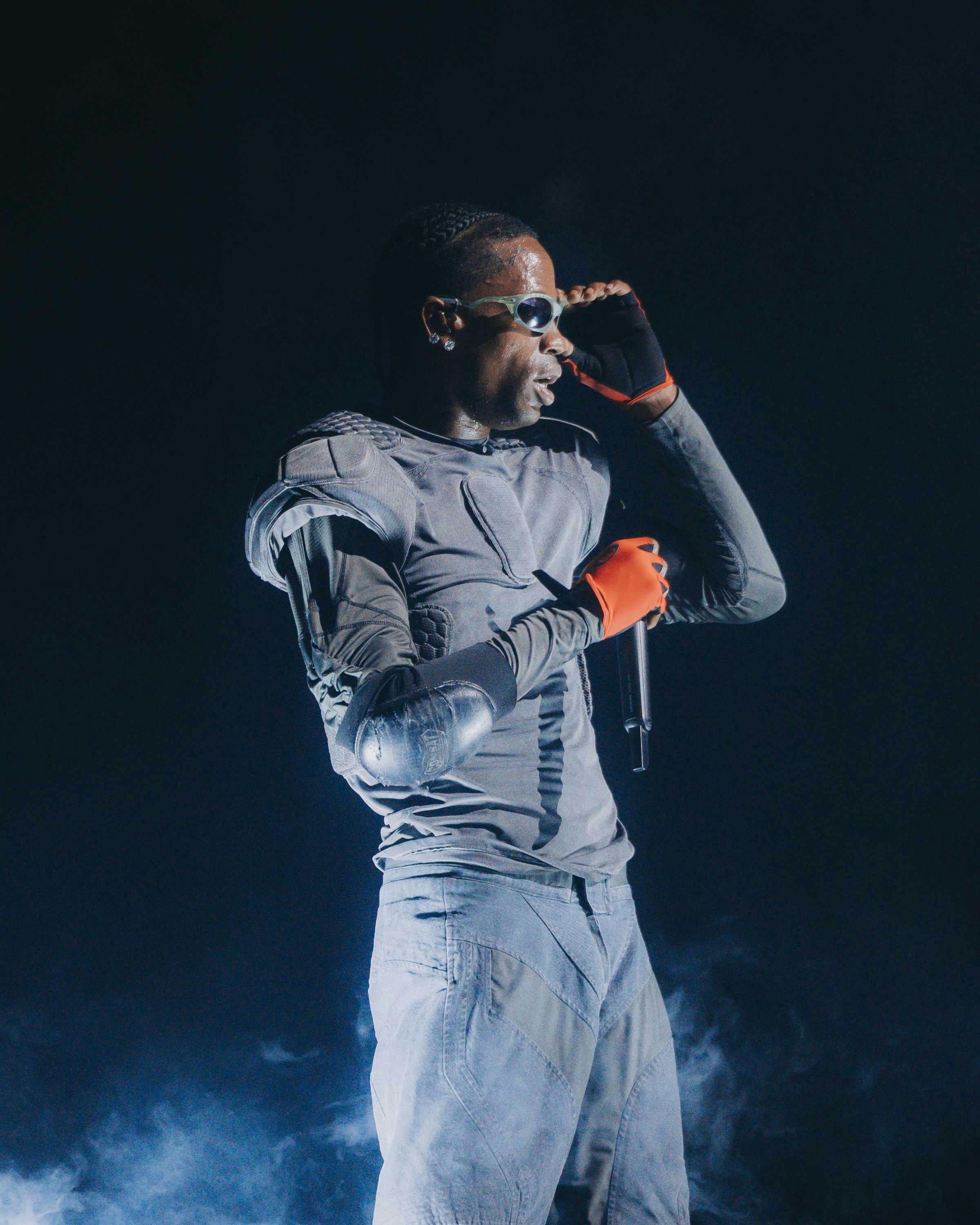 Travis Scott wears oakley sunglasses while performing live during circus maximus tour