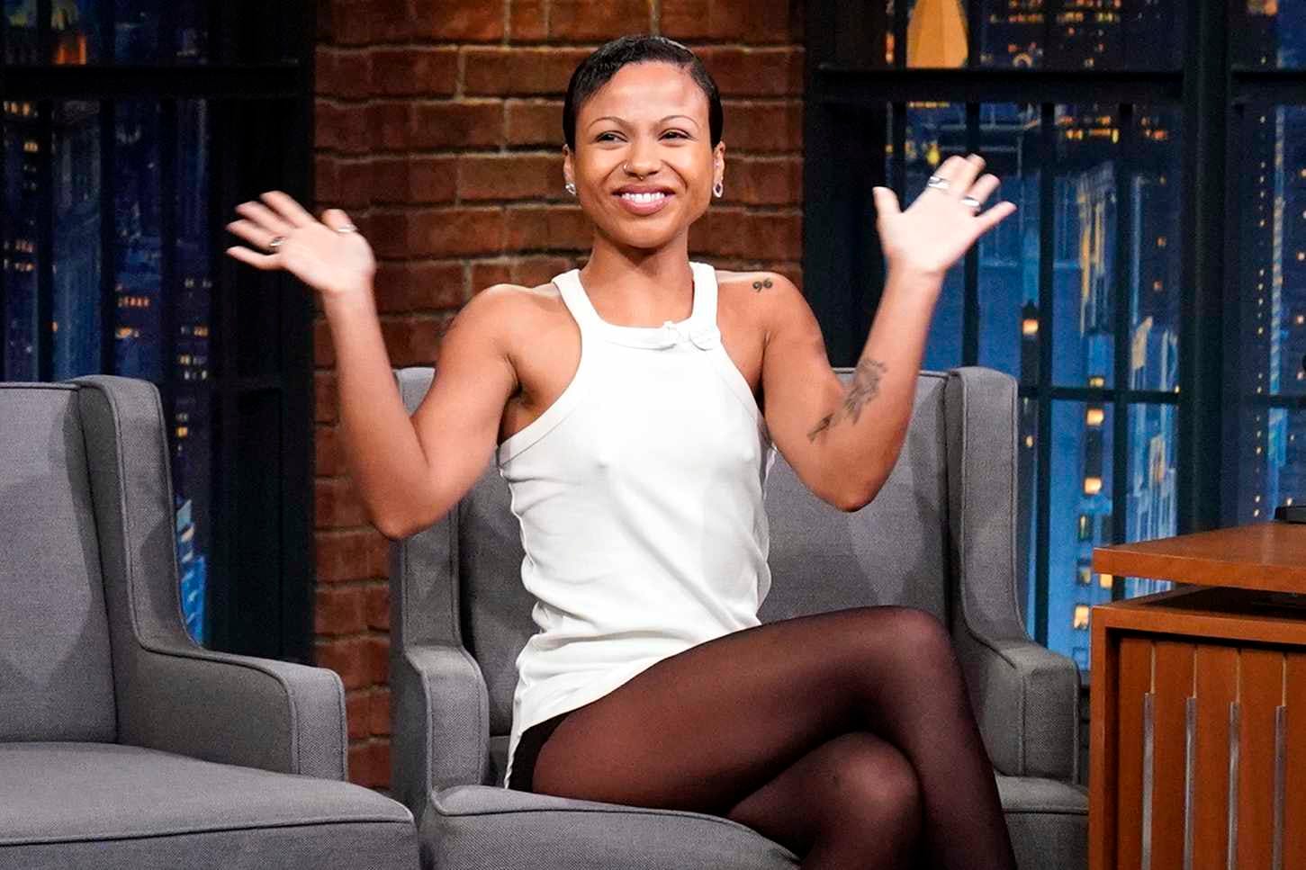 Myha'la wears white top and tights with white heels at seth myers talk show