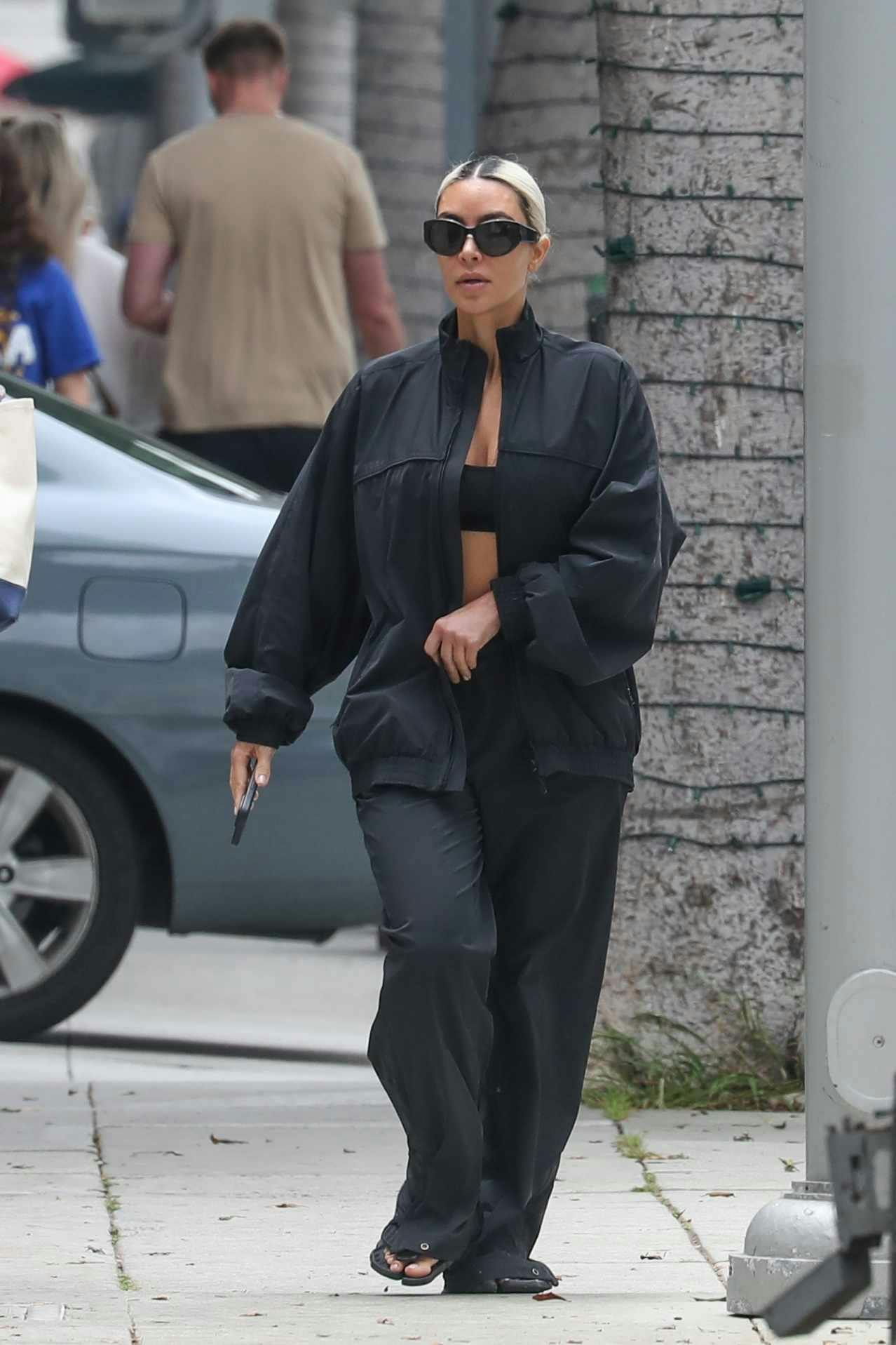 kim kardashian wears balenciaga sweatsuit and margiela tabi flip flops