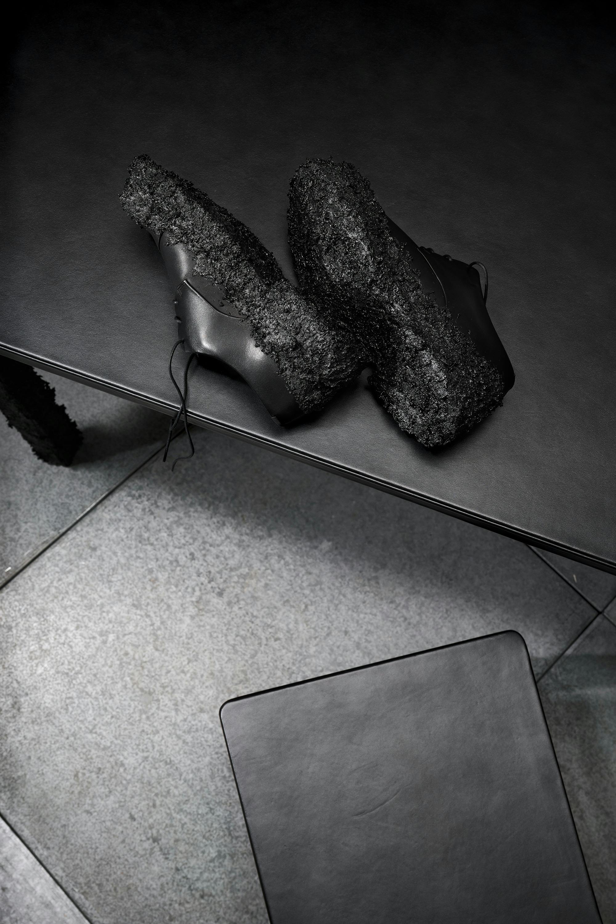 ECCO x Illya Goldman Gubin's collab shoes on a black table