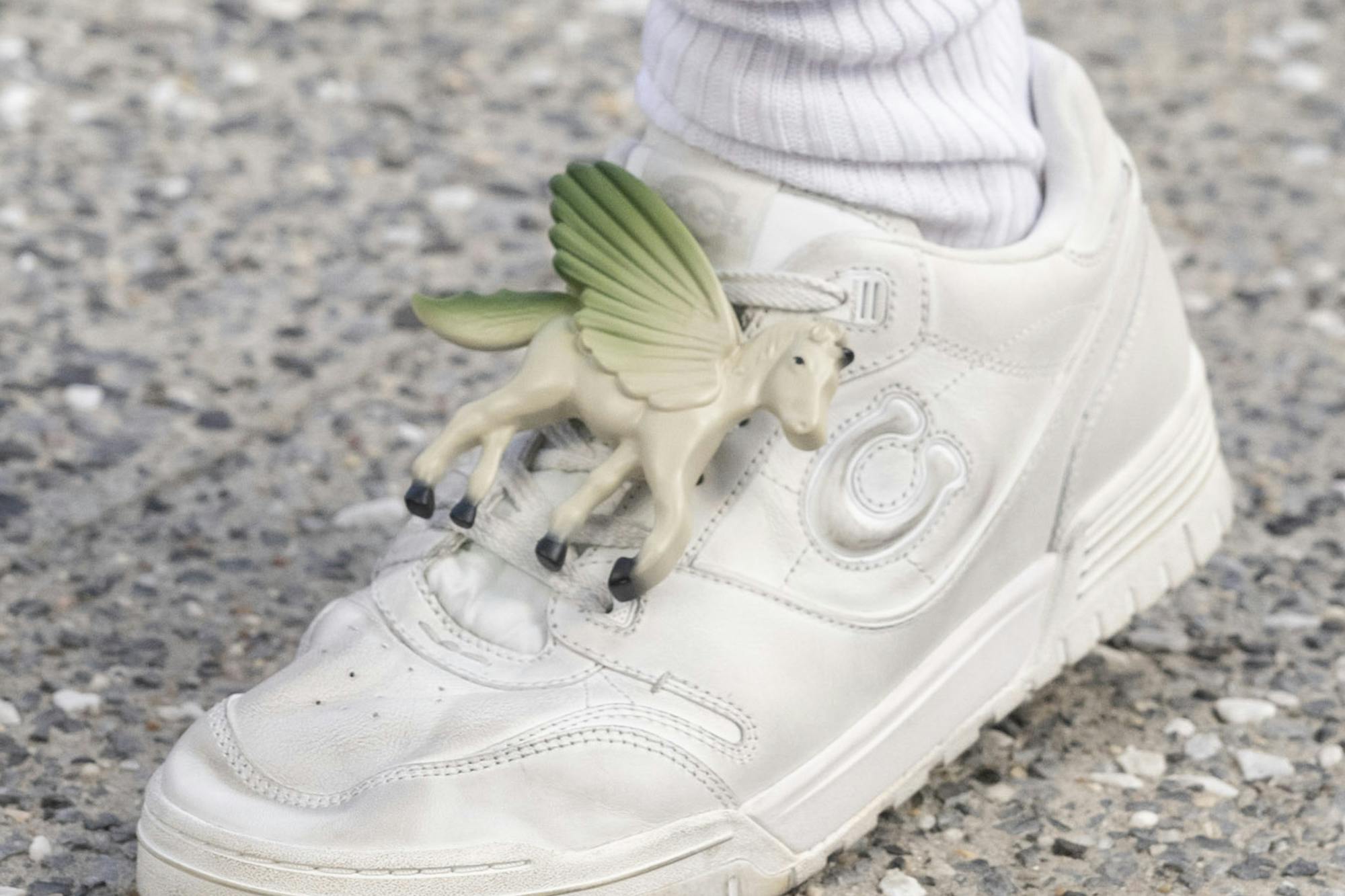 A unicorn-shaped charm on a sneaker at Coach's Spring/Summer 2025 runway show