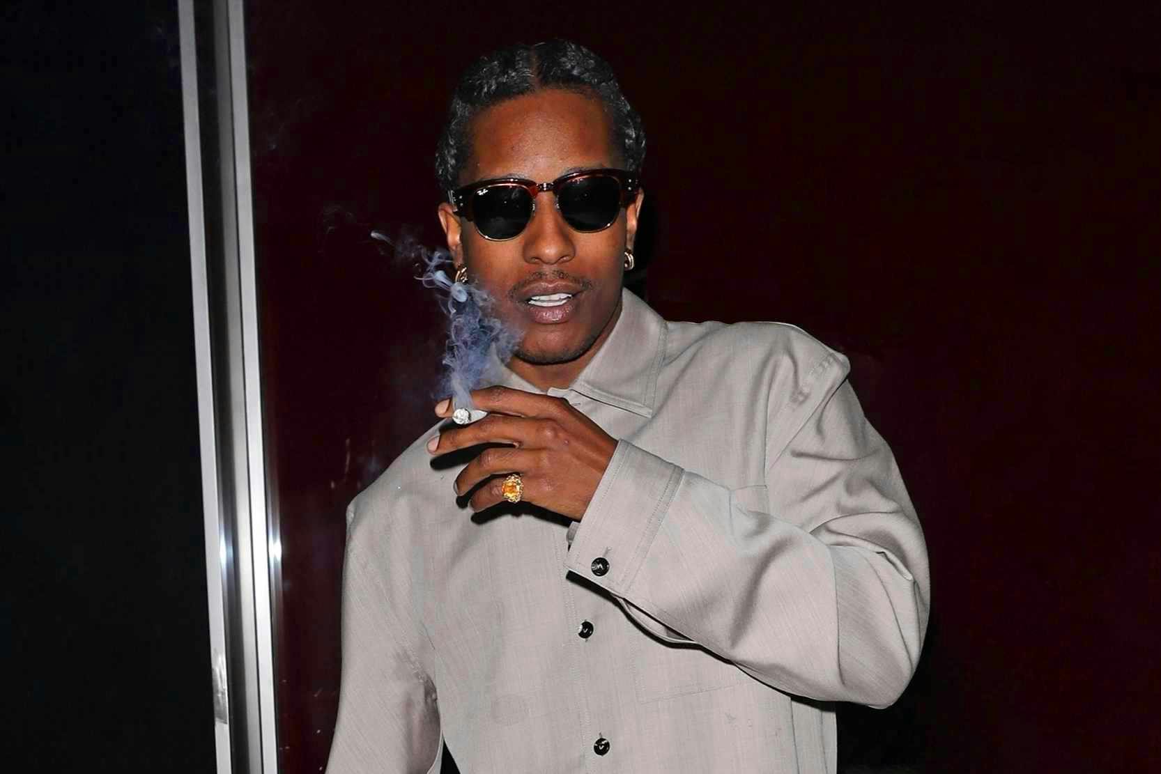 Asap rocky wears grey bottega shirt and slacks with black loafers and sunglasses at funke in los angeles