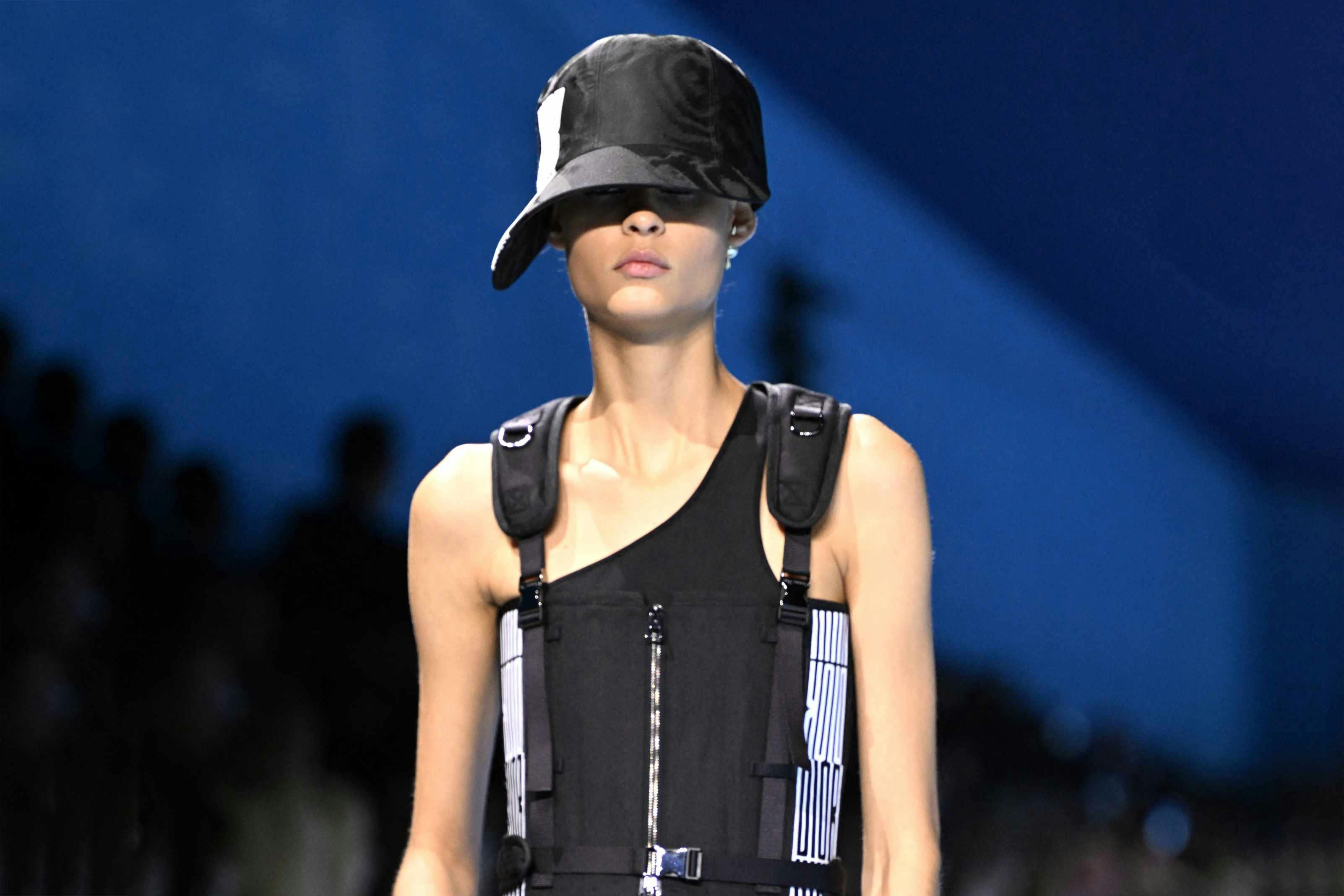 dior spring summer 2025 womenswear show model wears large hat and black buckled vest