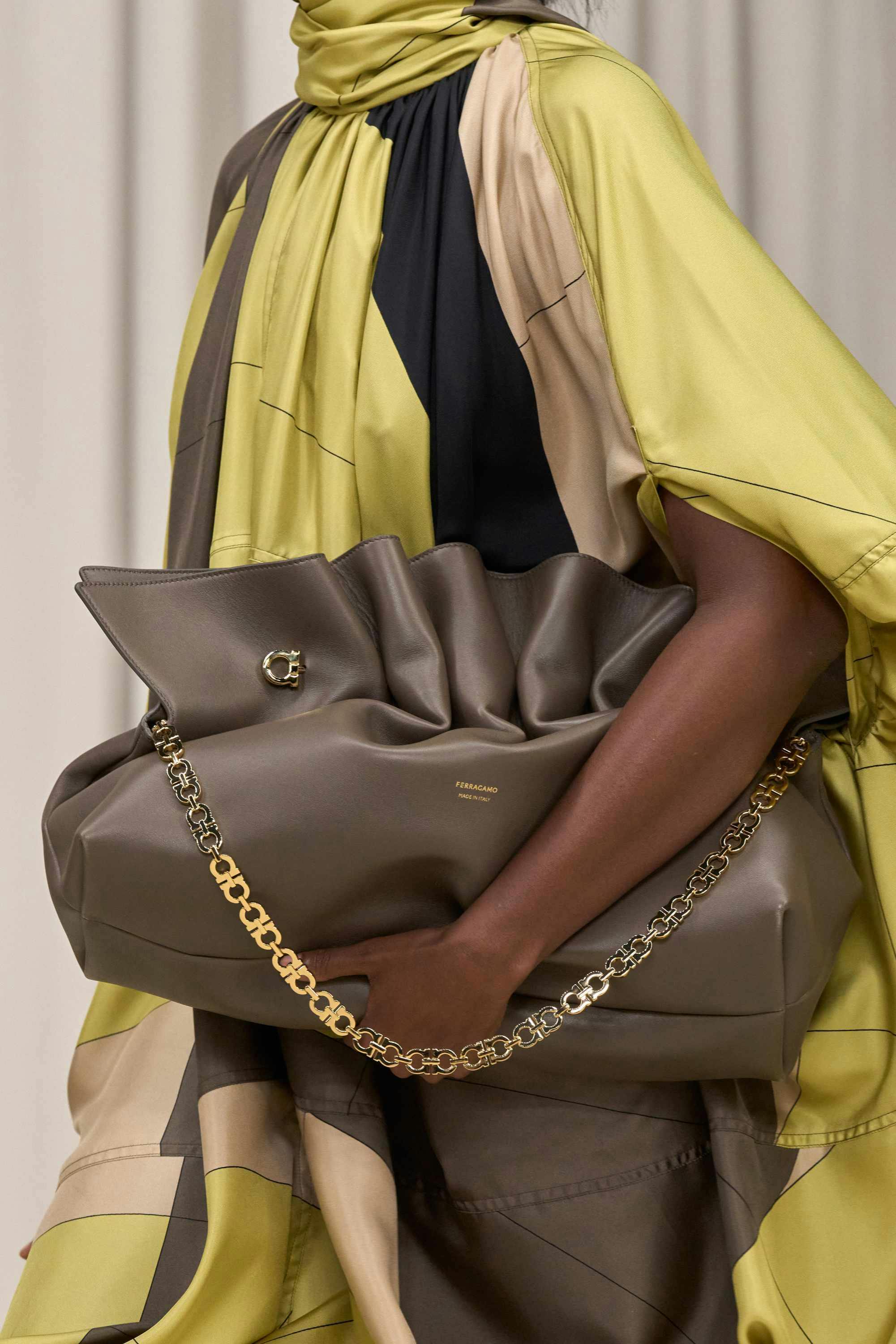 model with yellow coat and green ferragamo bag