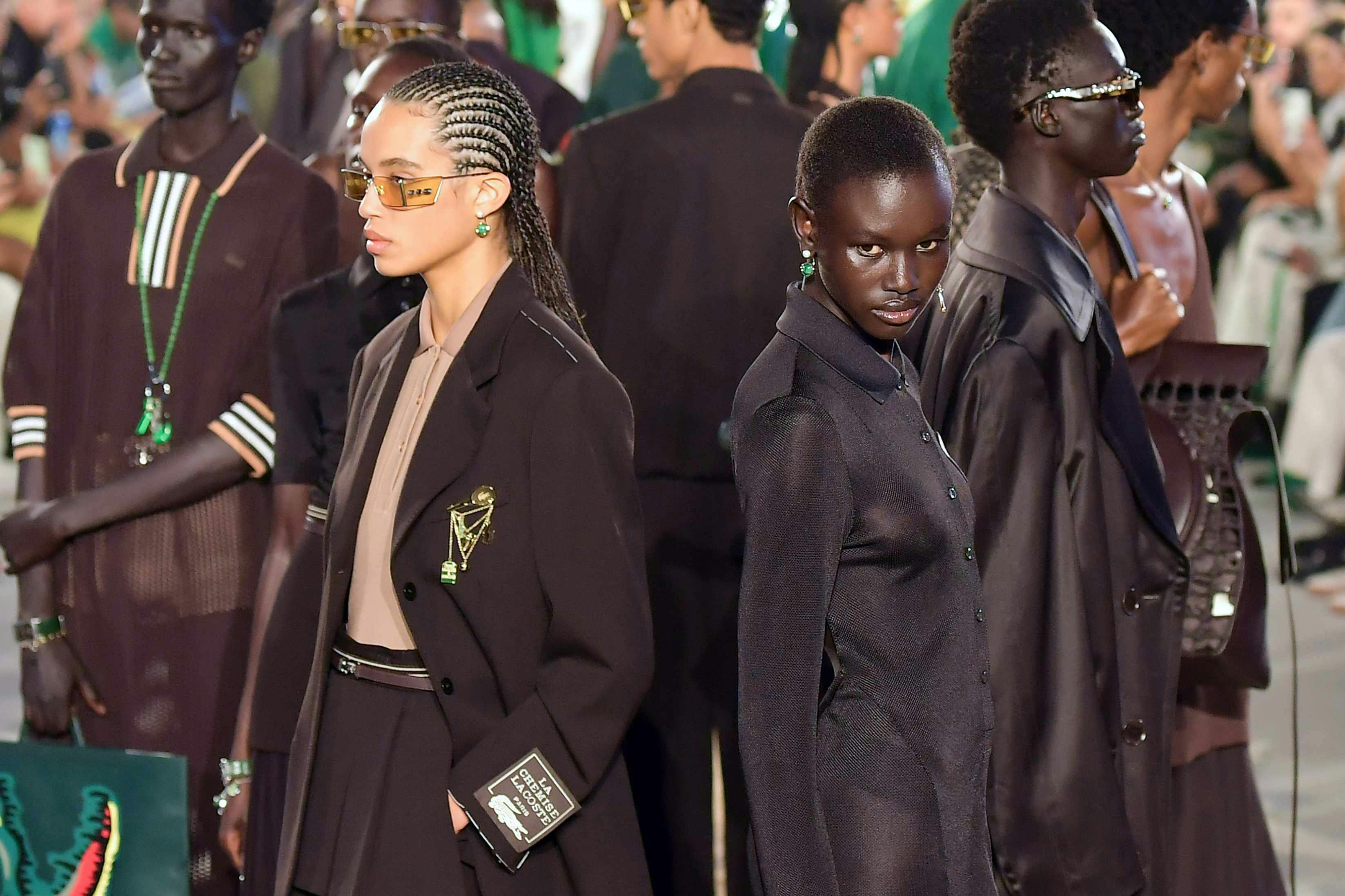 lacoste models at the spring summer 2025 fashion show wear dark suits