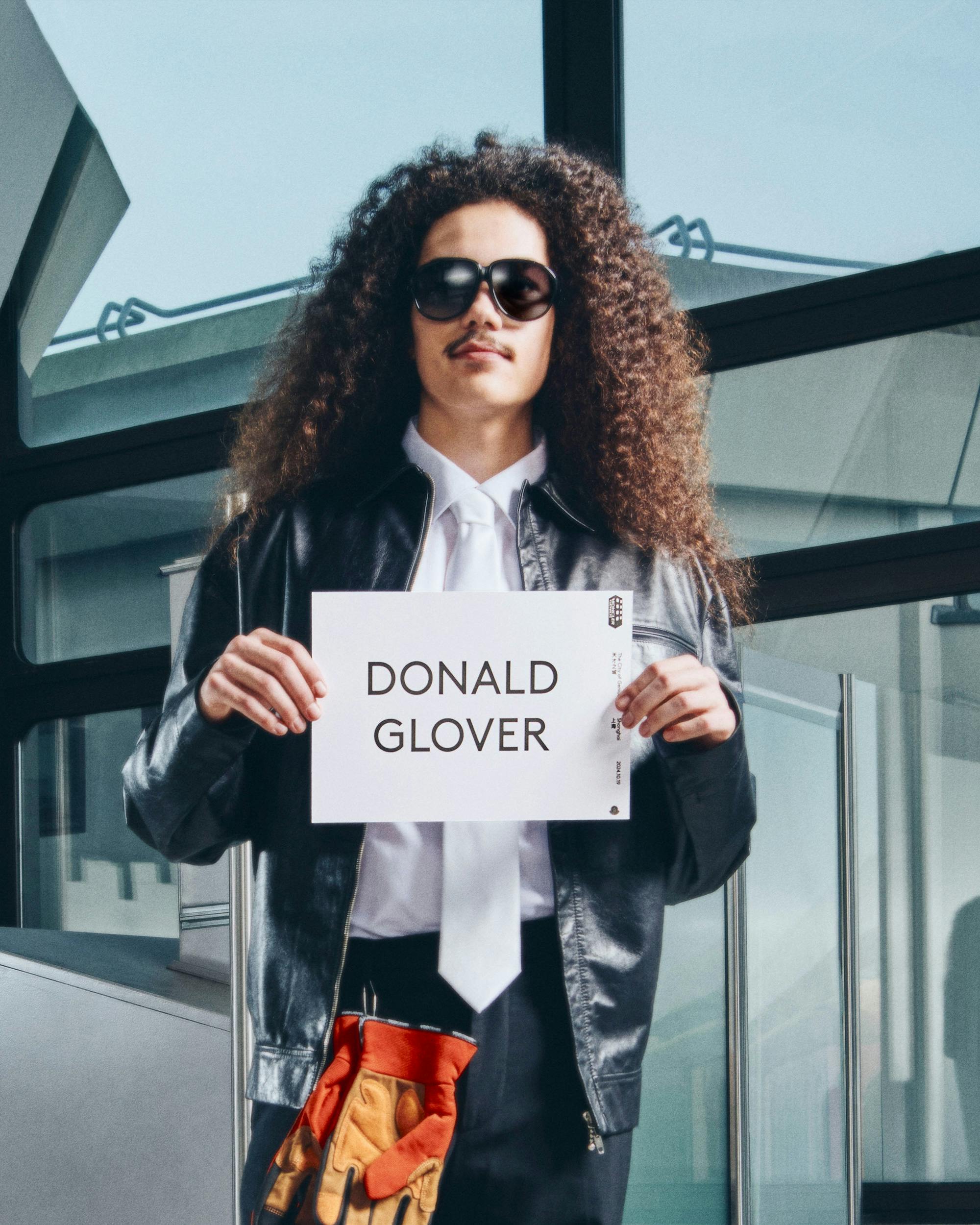 Moncler drivers holding name card with talent name to pick them up from airport