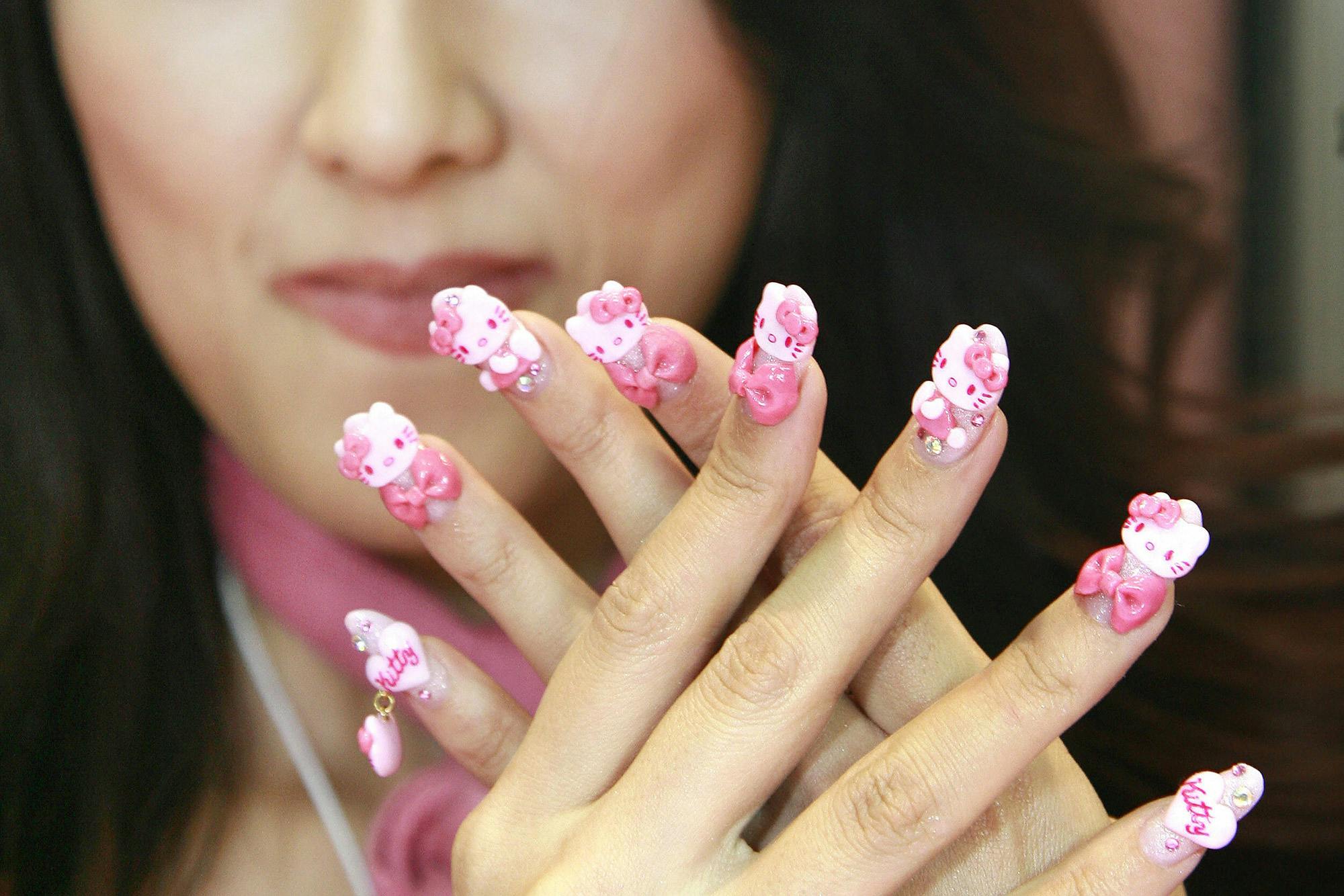 Japanese nail artist Yoko Matsuda displaying $150 Hello Kitty nail art in 2007.