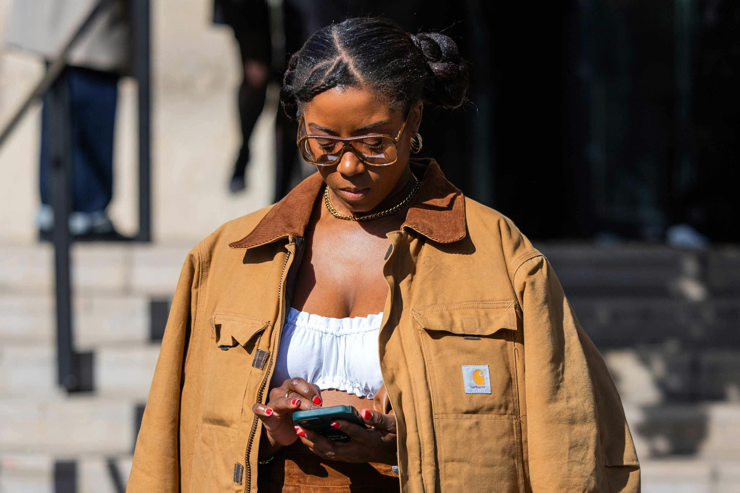 a fashion week guest wears a brown carhartt barn jacket