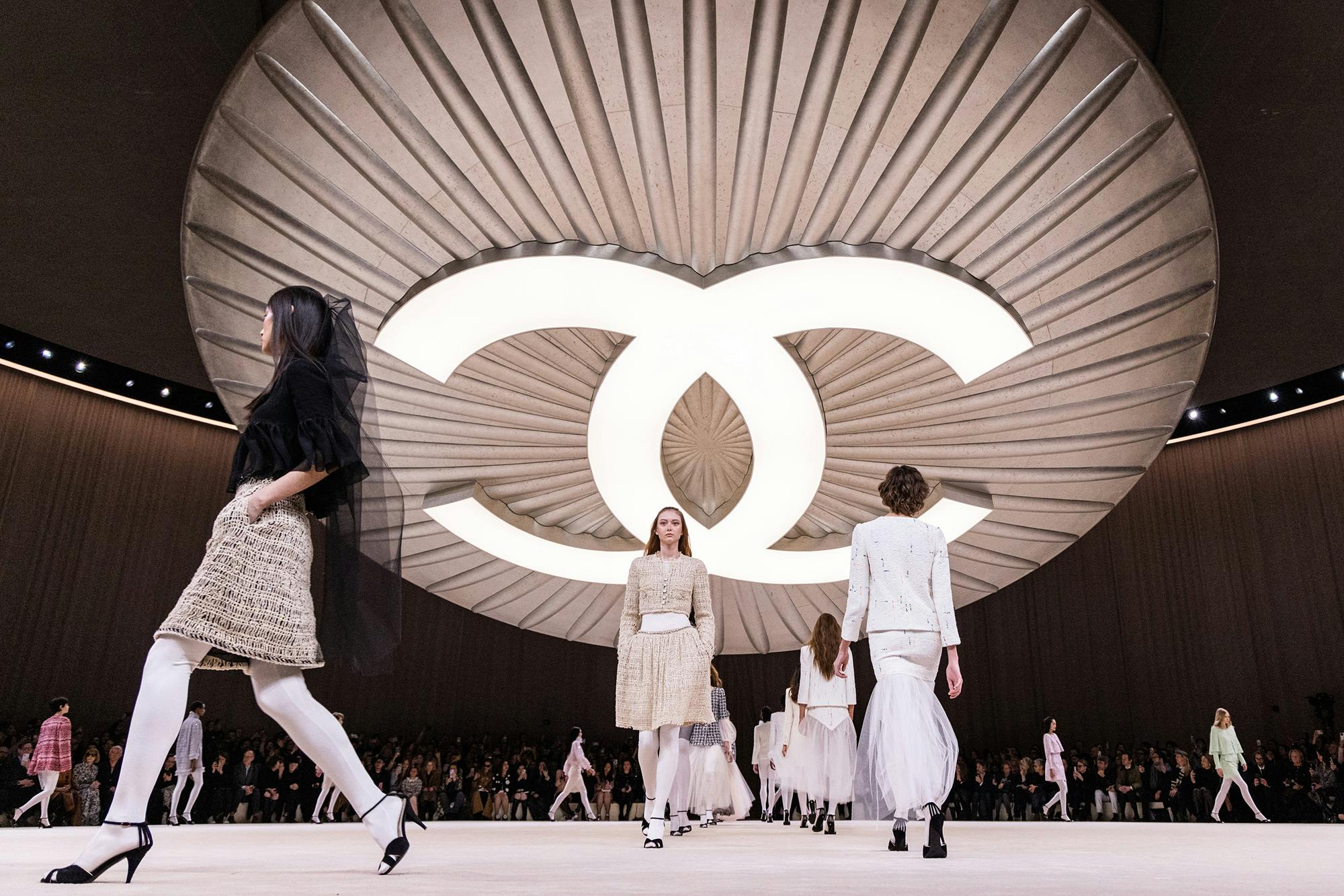 chanel runway logo with models wearing white clothes