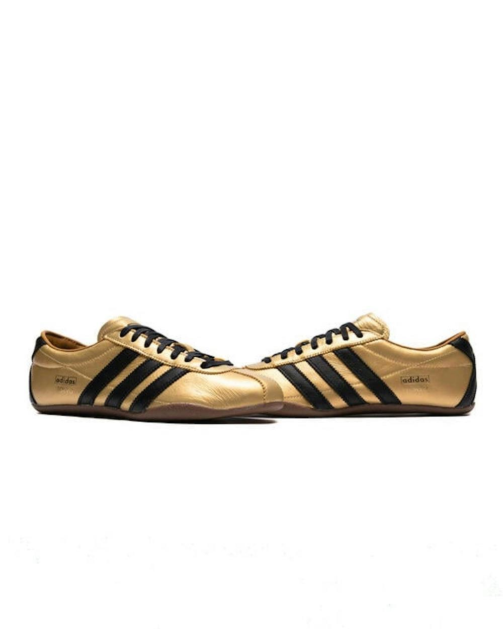 gold and black adidas sneaker