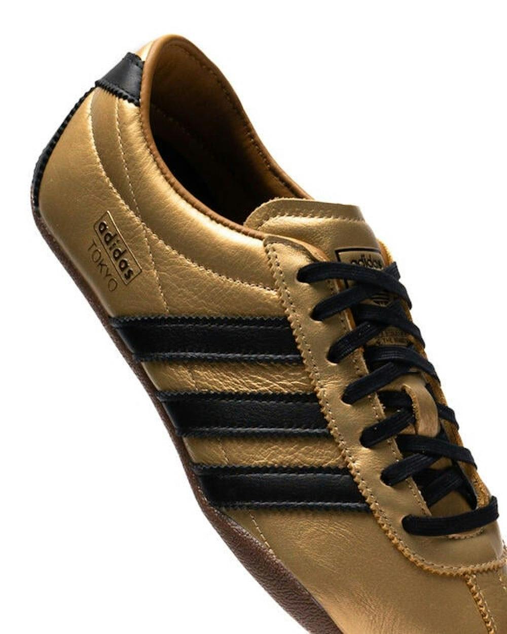 gold and black adidas sneaker