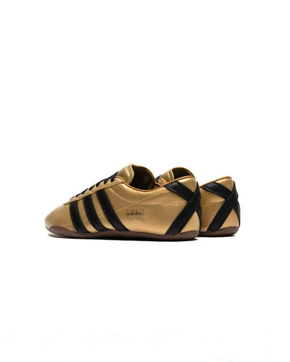 gold and black adidas sneaker