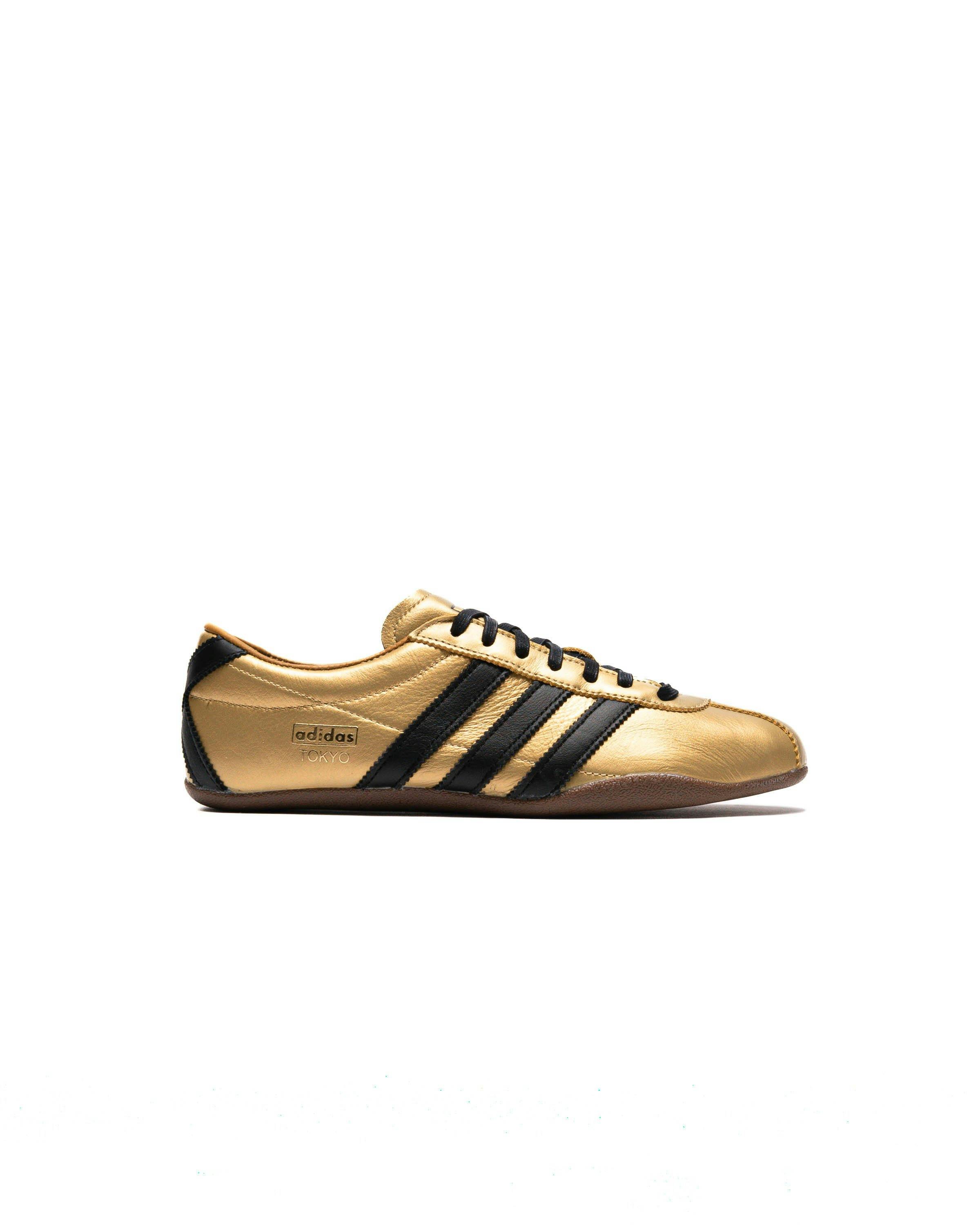 gold and black adidas sneaker