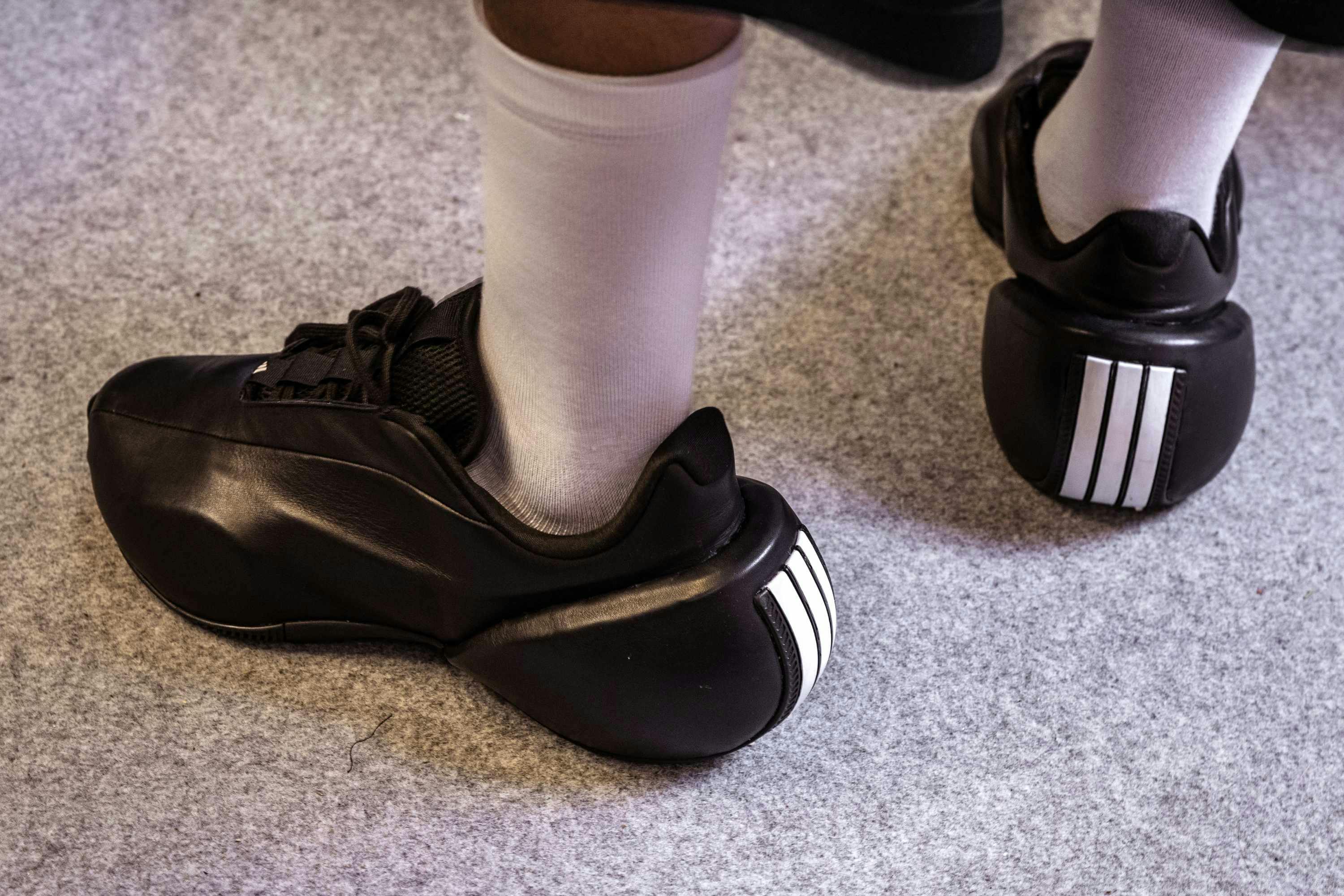 willy chavarria x adidas black leather sneaker with three white stripes on the heel from the fall/winter 2025 runway show